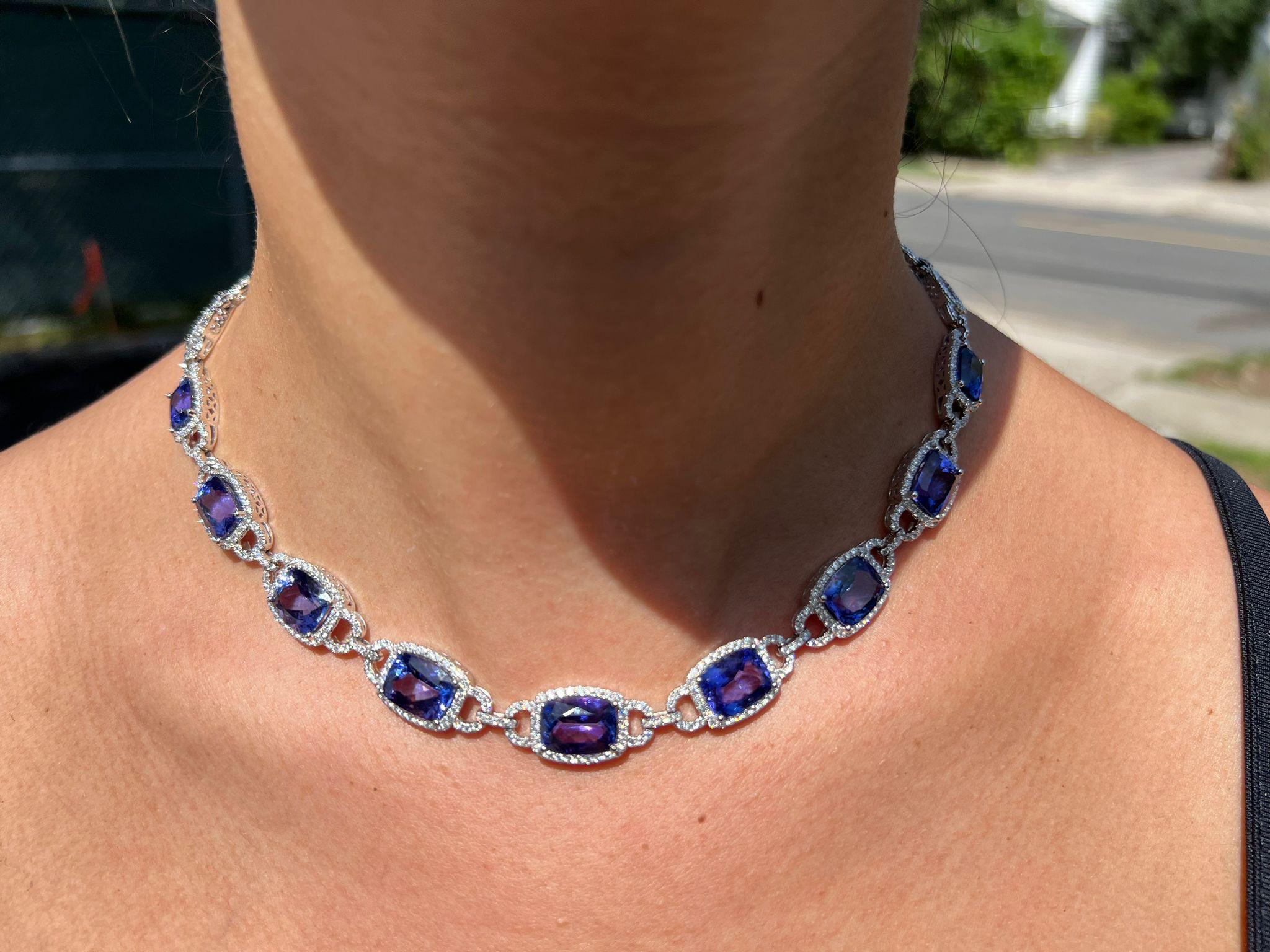  Indulge in the mesmerizing beauty of this exquisite 14 karat white gold necklace featuring a stunning cushion tanzanite pendant. Crafted with exceptional artistry, this necklace showcases the finest quality vivid AAA tanzanite weighing an