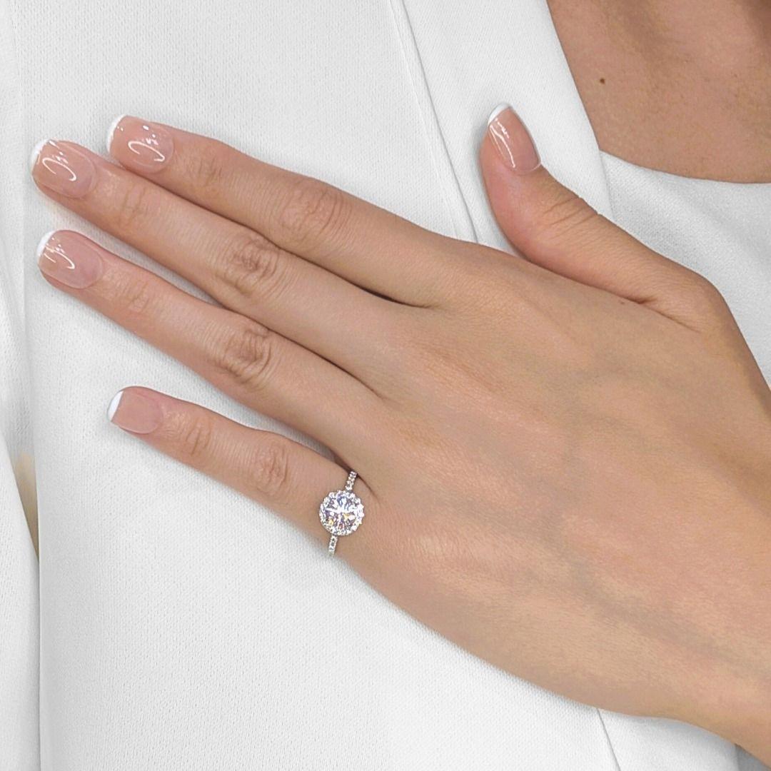 A dazzling showcase of brilliance, this halo pave ring features a striking 1.01ct round brilliant-cut diamond at its center, graded G color and SI2 clarity for a luminous presence. Surrounding it, 41 expertly placed natural diamonds, totaling 0.41