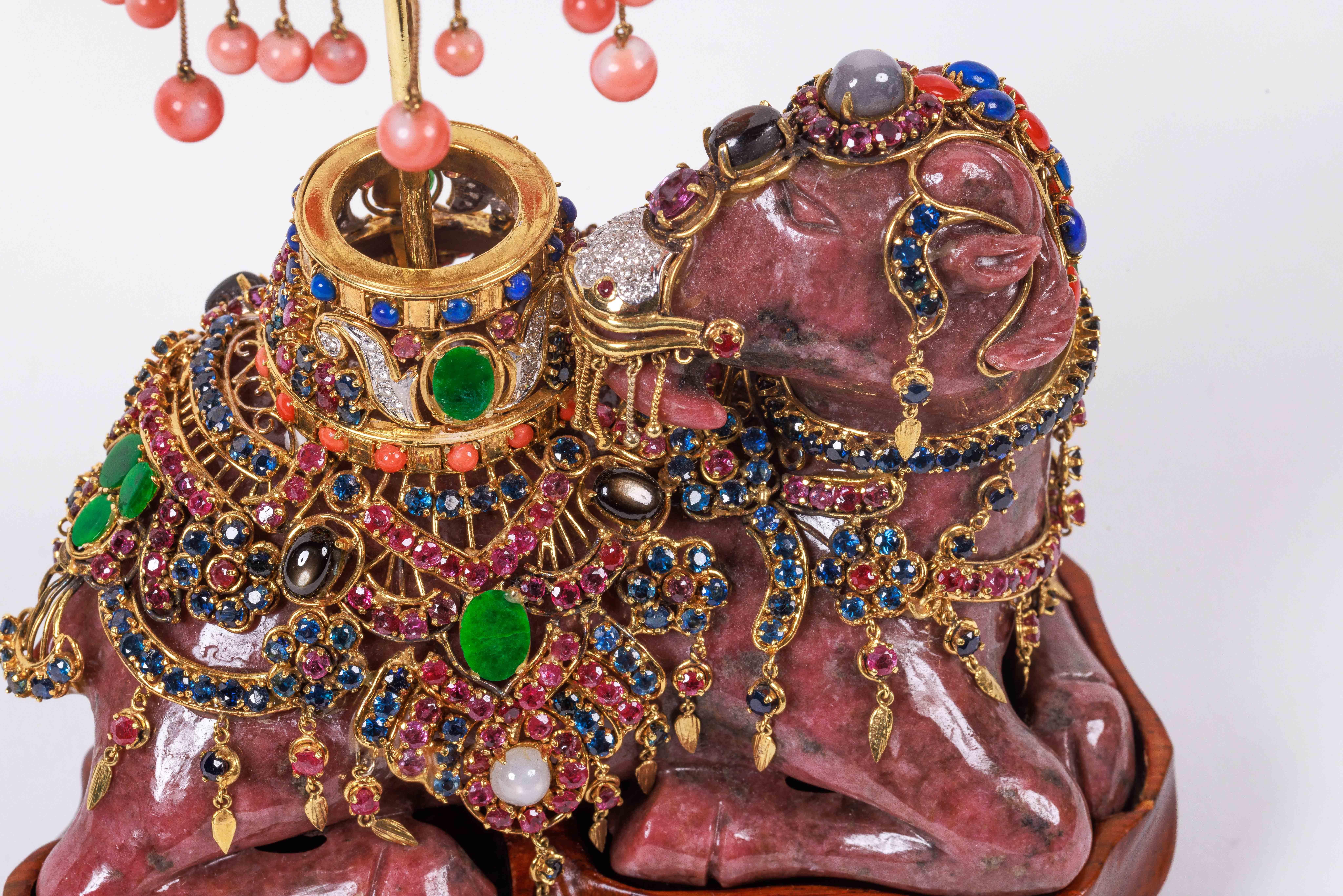 An Exquisite 14K Gold, Diamonds, Emeralds, Rubies, Sapphires, and Semi Precious Stone Mounted Rhodonite Camel. 

Possibly by Verdura, circa 1970, Italy.

A very good quality and unusual gold mounted jeweled object, depicting a seated camel