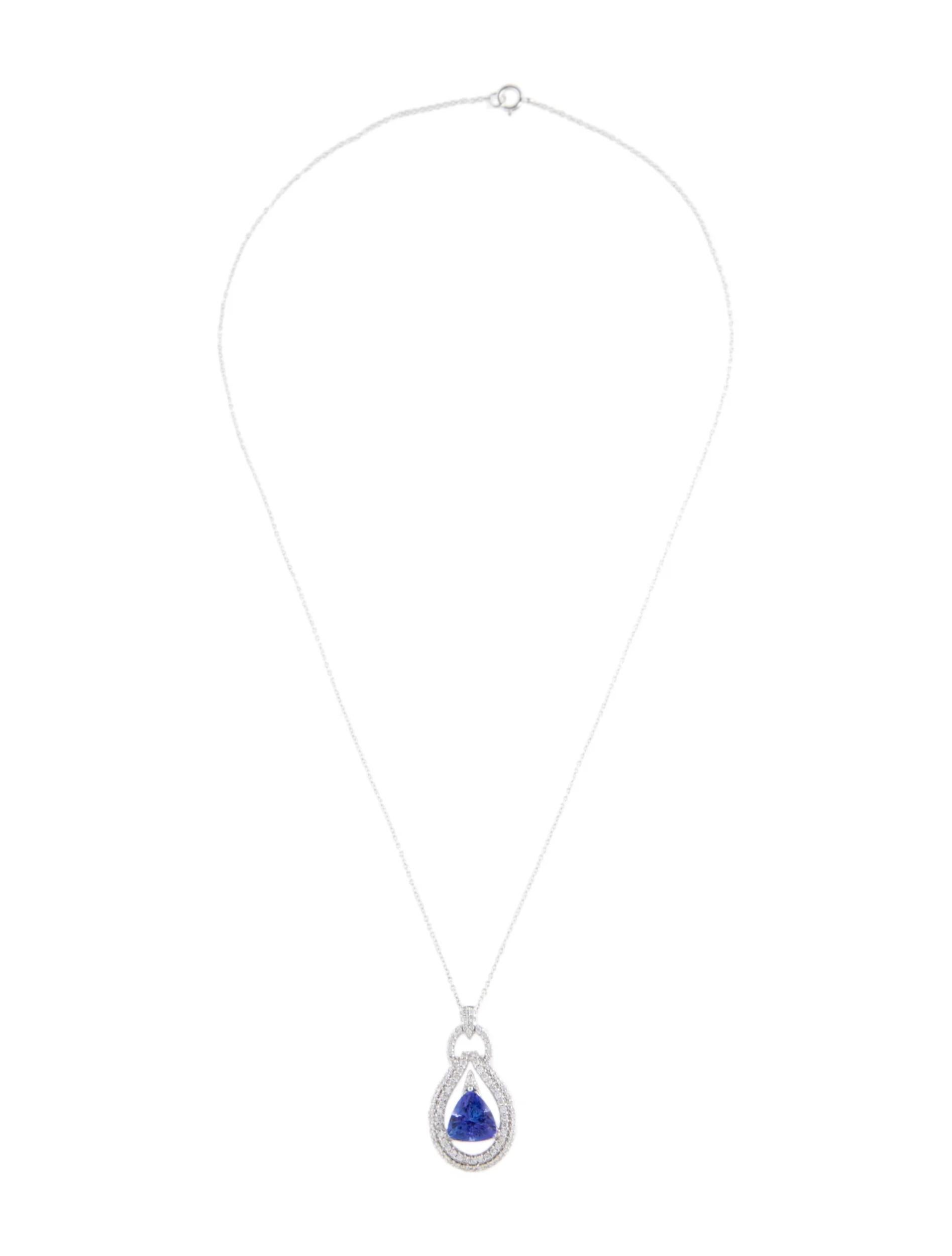 Elevate your style with this exquisite 14K white gold pendant necklace. The centerpiece features a captivating tanzanite gemstone, weighing 2.75 carats, in a modified triangular brilliant cut. Its enchanting violet hue adds a touch of elegance to