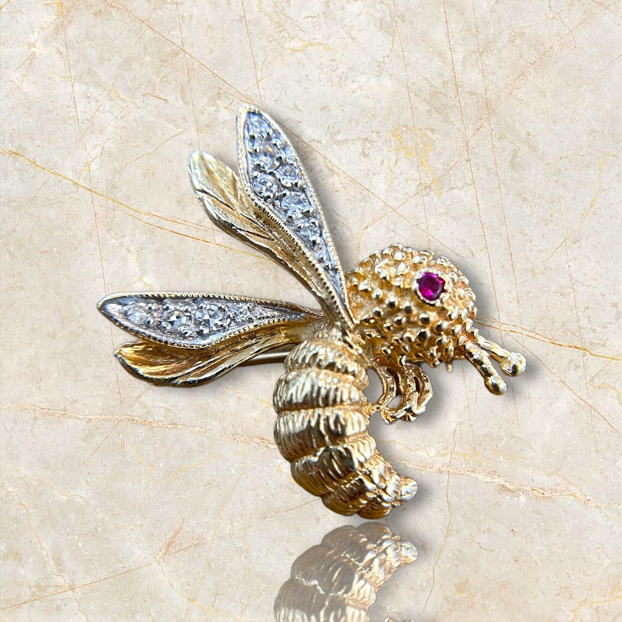 Add a touch of whimsy and elegance to your collection with this 14K Yellow Gold Bumblebee Brooch. This charming piece features a ruby eye and natural diamonds, creating a sparkling and delightful design. Perfect for any occasion, this brooch