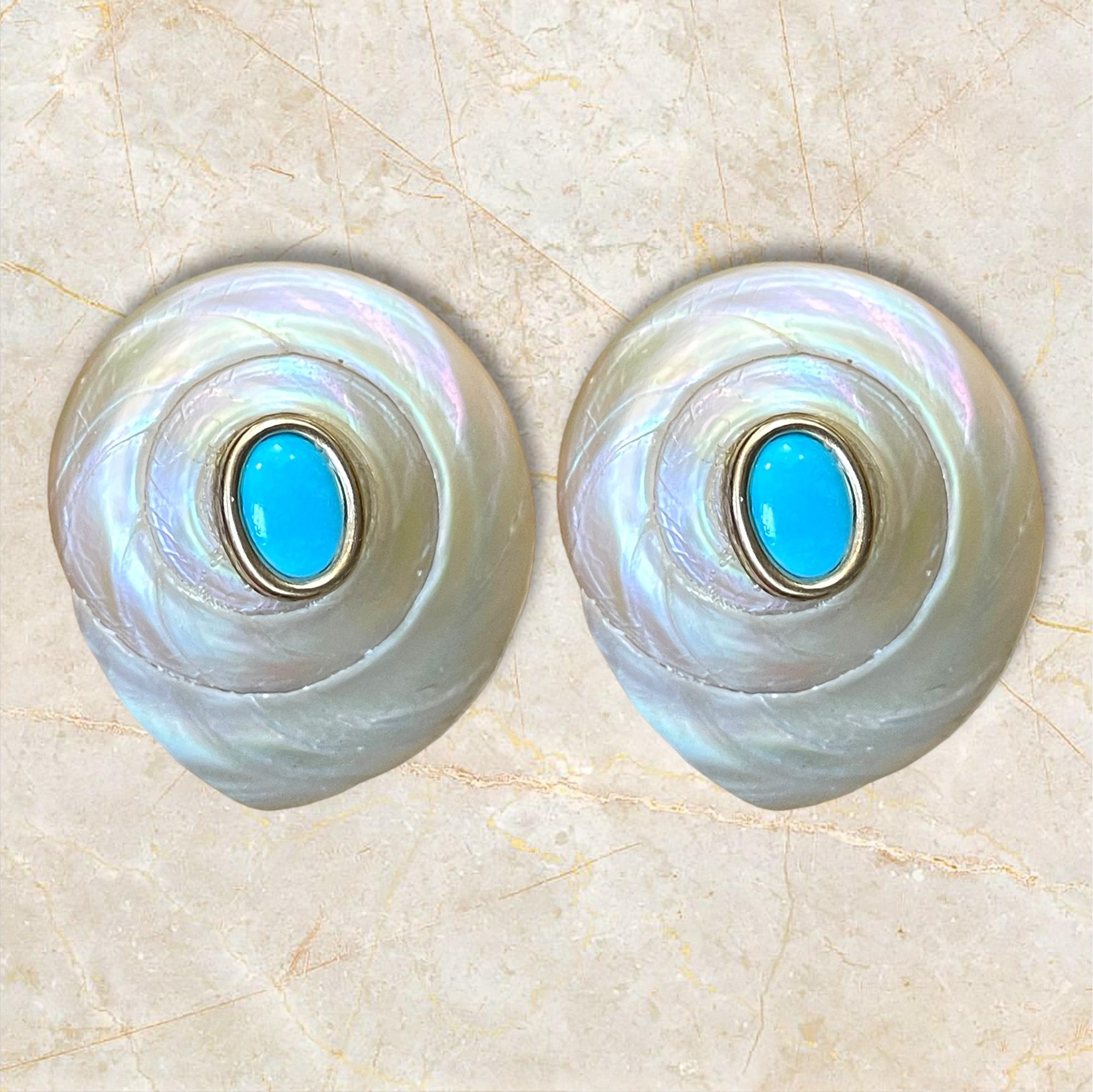 These exquisite 14K yellow gold earrings feature large, intricately designed shell motifs, highlighted by vibrant turquoise centers. Their unique and elegant design makes them a perfect statement piece, adding a touch of luxury and sophistication to