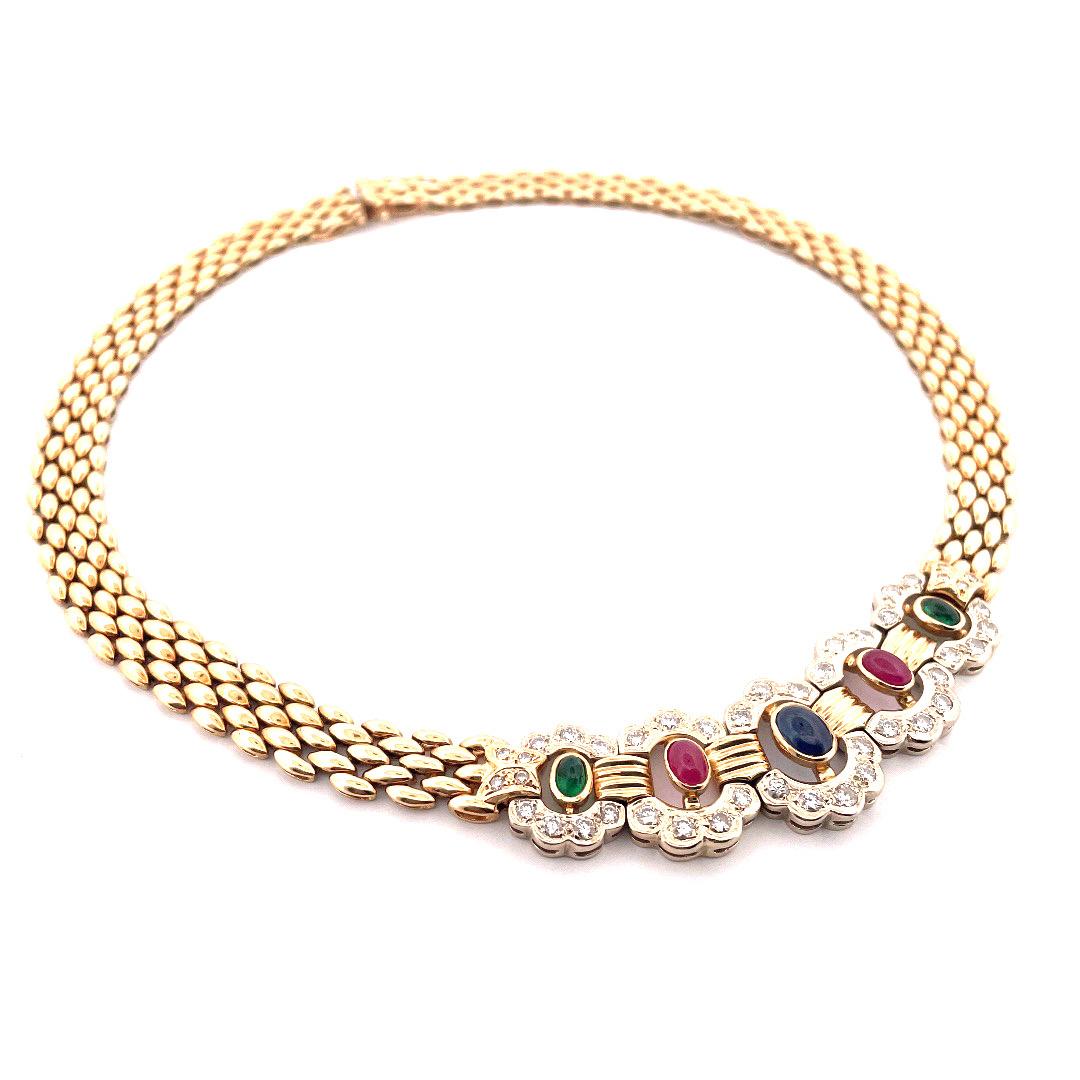 Elevate your jewelry collection with this exquisite 14k yellow gold multi gemstone diamond necklace. The necklace showcases two captivating oval-shaped emeralds, two radiant rubies, and one alluring sapphire, all surrounded by a dazzling halo of