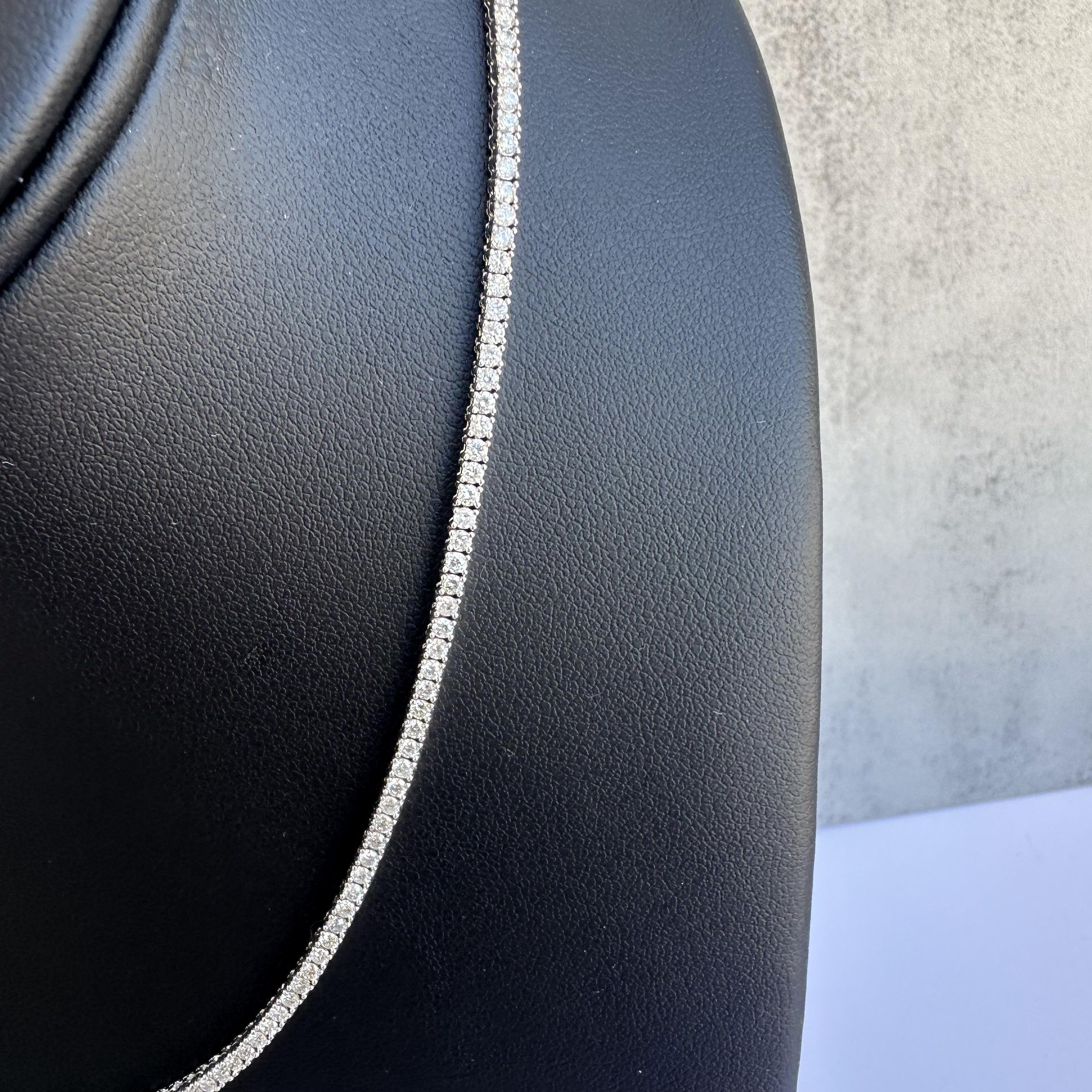Introducing our breathtaking 14kt White Gold Diamond Tennis Necklace:  
A masterpiece of luxury and precision. This exquisite piece features 4.50 carats of GH color, SI2-I1 clarity natural diamonds, meticulously set in a classic straight line tennis