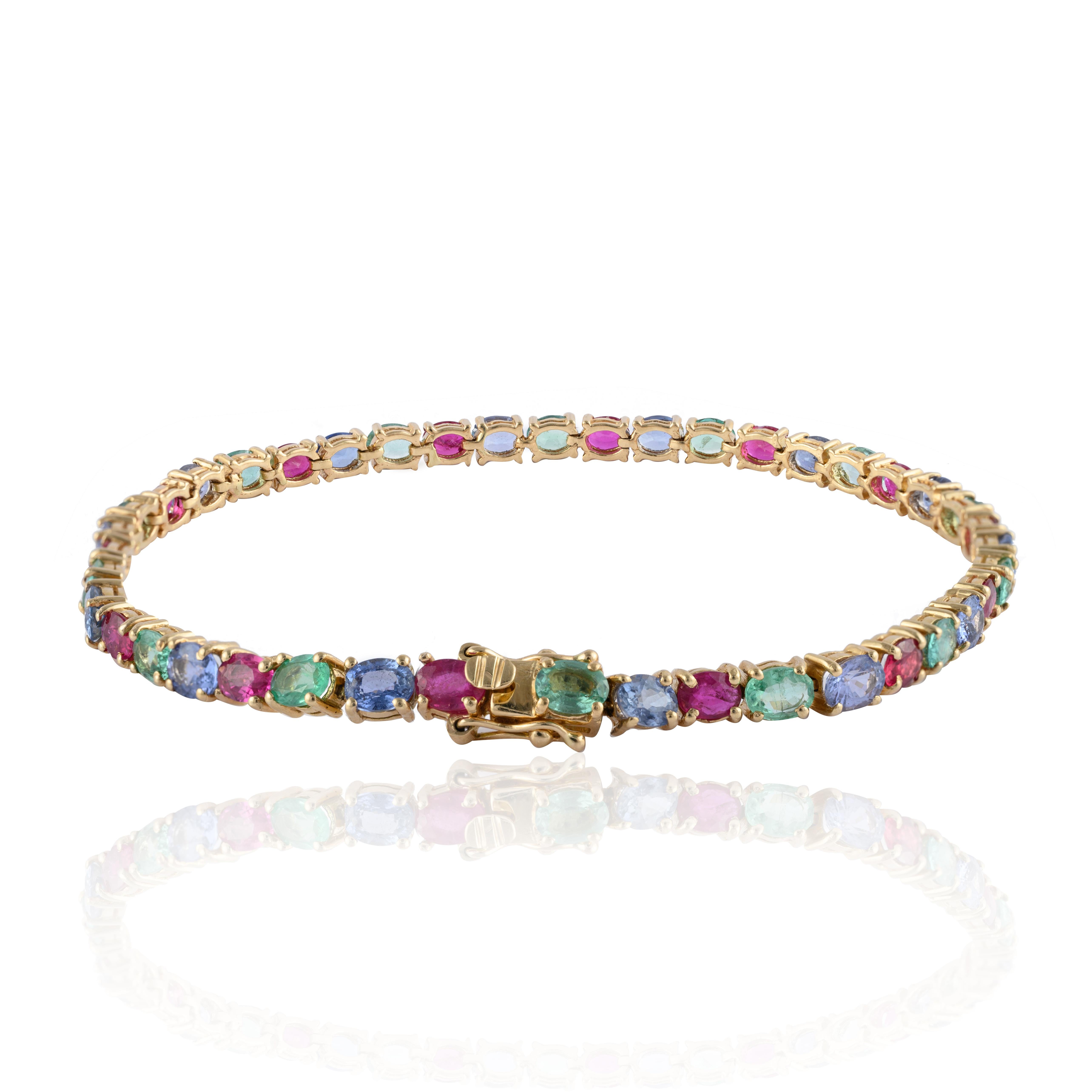 Exquisite Emerald, Ruby and Sapphire Tennis Bracelet in 14K gold showcases 42 endlessly sparkling natural rubies, emeralds and sapphires weighing 15.25 carats. It measures 7.5 inches long in length. 
Ruby improves mental health, sapphire stimulates