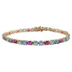 Magnifique bracelet tennis en or jaune 14 carats avec émeraudes, rubis et saphirs de 15,25 carats