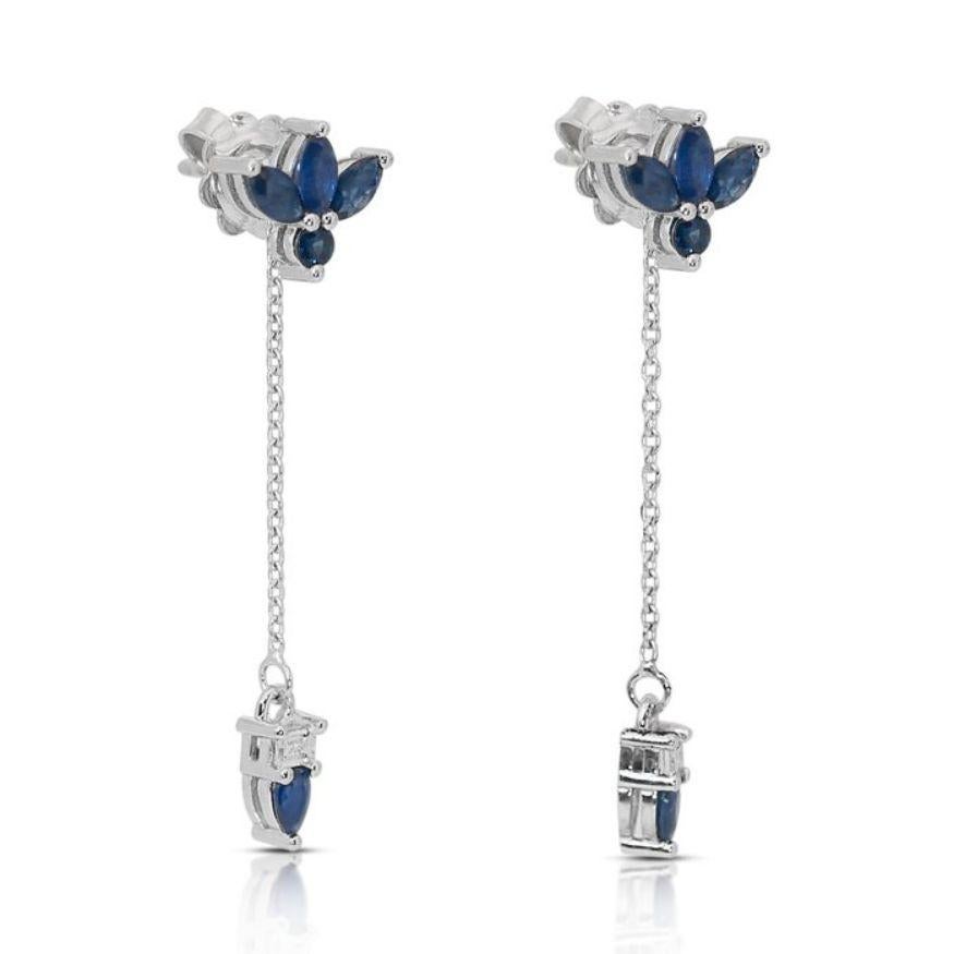 These exquisite earrings boast a striking combination of diamonds and sapphires, each element contributing to their timeless beauty. This earring have a dazzling two baguette-cut diamond weighing 0.20 carats. These diamonds are of the highest