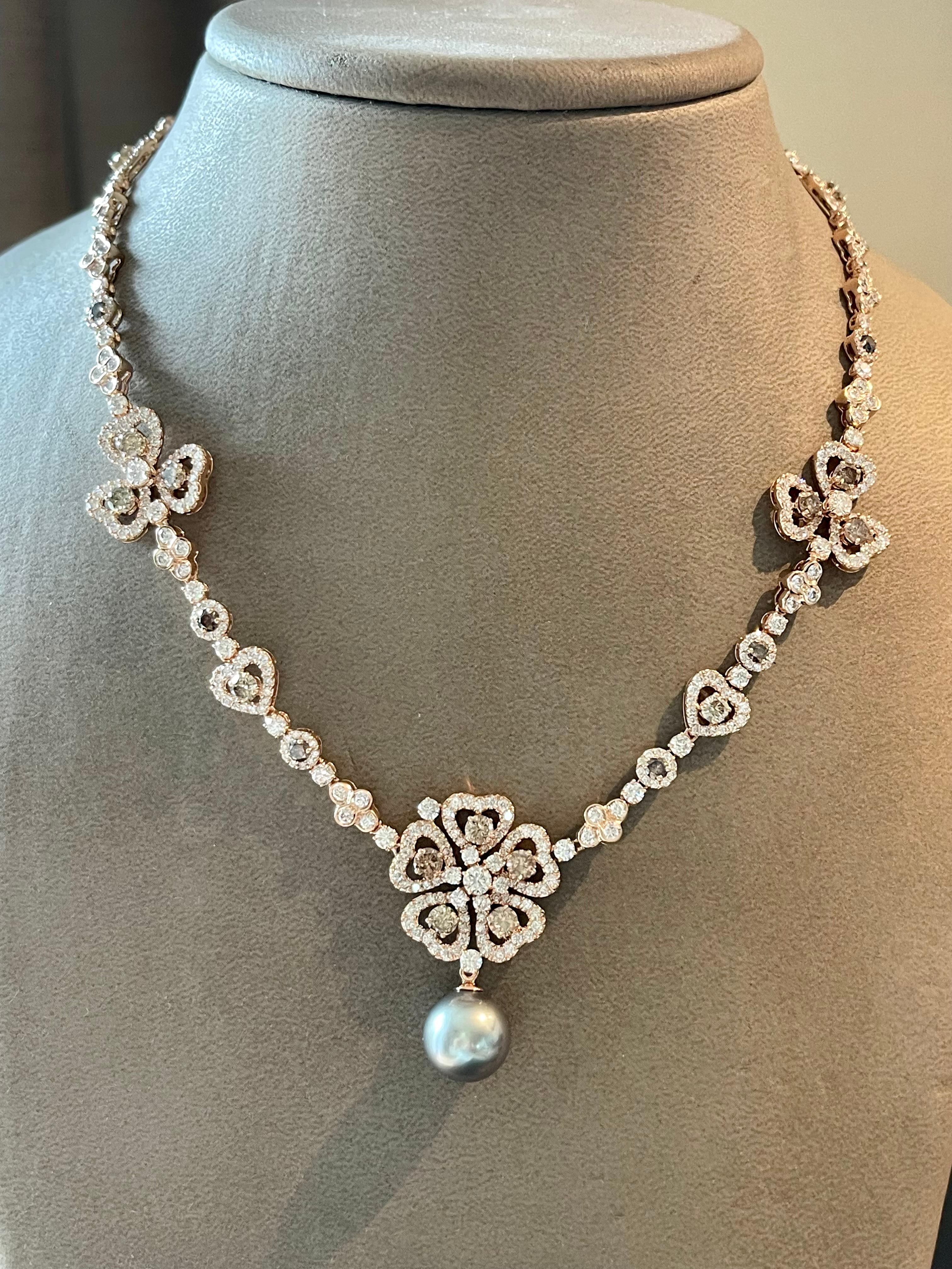 Lovely 18 K rose Gold necklace in a timeless flower style design. The necklace features a total of 471 white and Champagne colored brilliant cut Diamonds weiging     13.80 ct. There is a special device/hook on the central big Flower pendant that