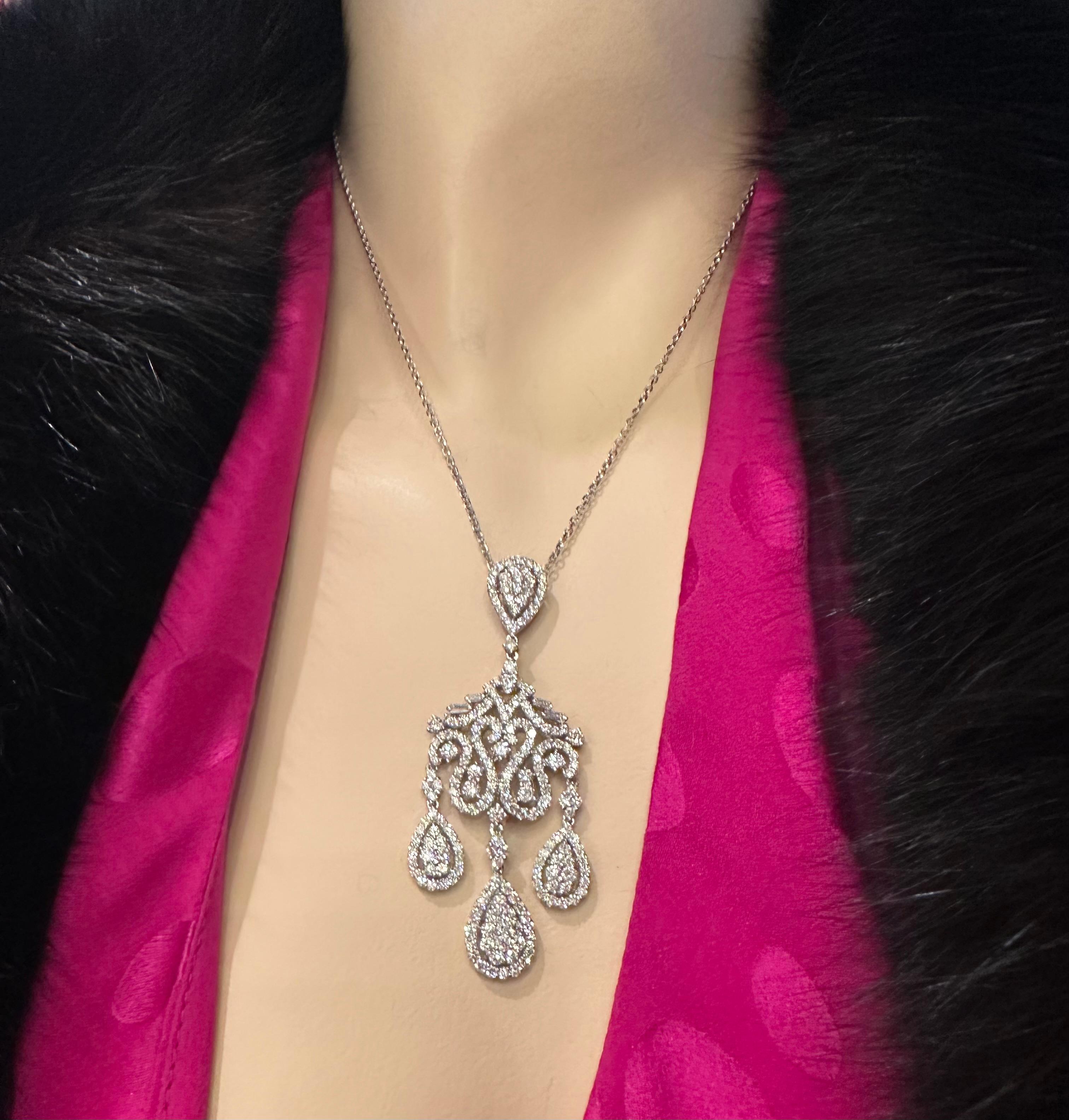 Exquisite ladies 18 karat white gold 9.76 carat diamond chandelier style drop necklace presents a show stopping array of round brilliant and baguette diamonds that sparkle with unparalleled brilliance.  Necklace features a cascading trio of pear