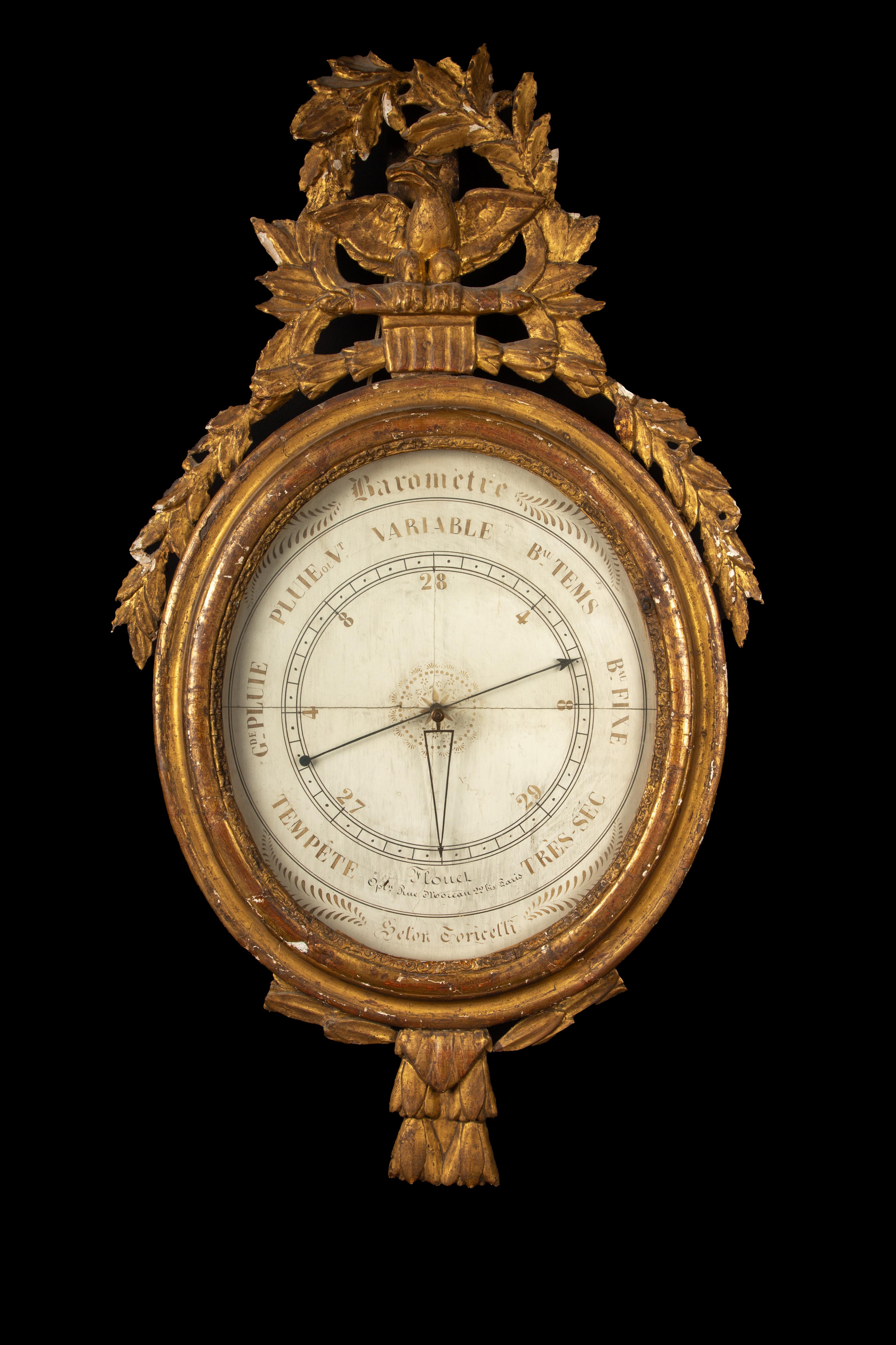 This Mercury barometer, housed in a stunning gilded wood ring frame adorned with a skillfully carved pediment featuring an eagle and delicate oak leaves, exemplifies the exquisite craftsmanship of its time. The meticulous detailing on the frame adds