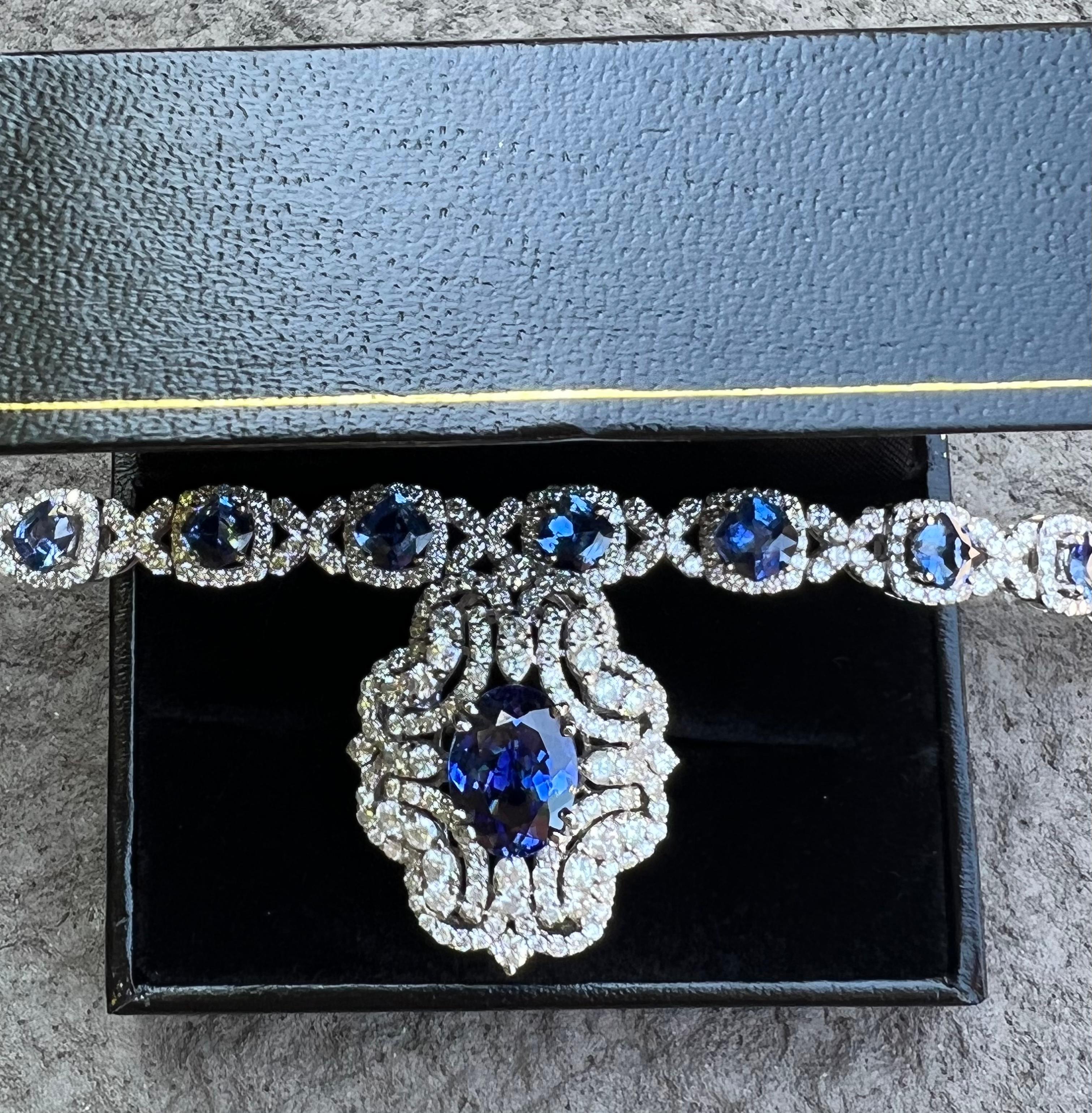 Very exquisite, estate 15.83 carat Ceylon sapphire and diamond 18 karat white gold tennis or line bracelet features 12 beautifully matched, cushion cut Ceylon sapphires mounted in 4 prong stations, surrounded by a halo of the most sparkling round