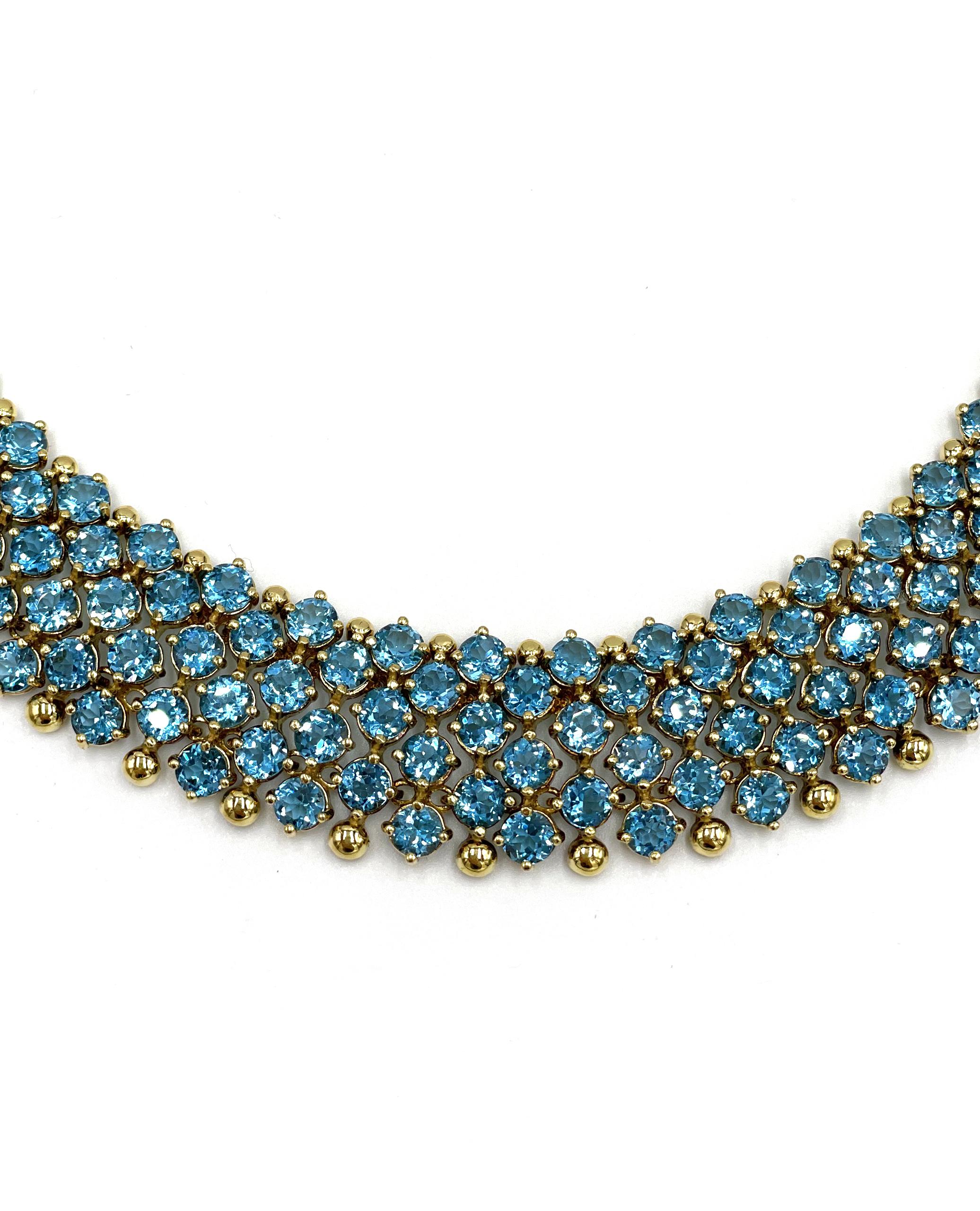 18K yellow gold collar necklace with 315 round brilliant-cut swiss blue topaz weighing a total weight 62.05 carats.

-Length: 16 inches