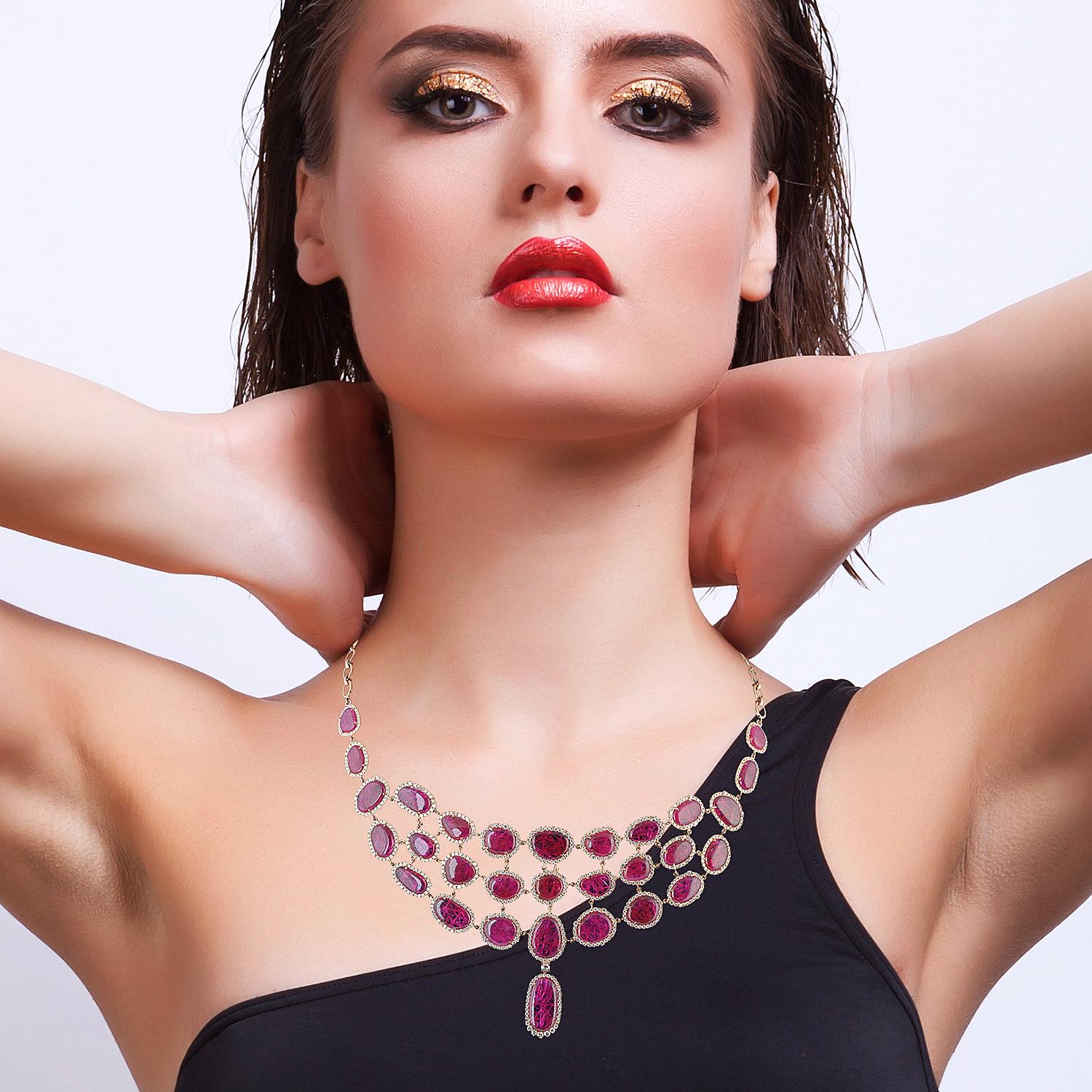 Cast in 14-karat gold, this exquisite necklace is hand set in 59.59 carats of natural rubies and 6.64-carats of glimmering diamonds.  The tiered choker style makes a great statement piece. 

FOLLOW  MEGHNA JEWELS storefront to view the latest