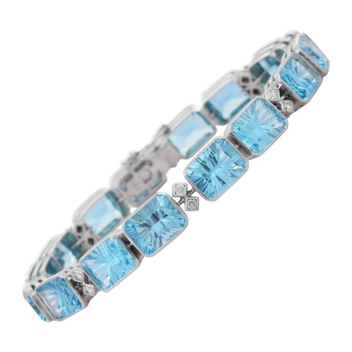 This Exquisite 18k White Gold Diamond and Fine Cut 40Carat Blue Topaz Tennis Bracelet showcases 16 endlessly sparkling natural blue topaz, weighing 40 carats. It measures 7.5 inches long in length. 
Blue topaz helps to improve communication and self