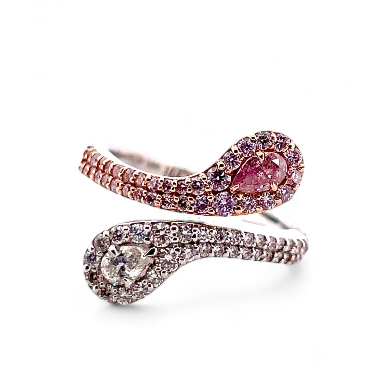 Experience the epitome of elegance with this 18k white gold ring adorned with natural diamonds. A striking fusion of sophistication and modern allure, this ring features a captivating pink and white pear shaped diamonds, radiating warmth and