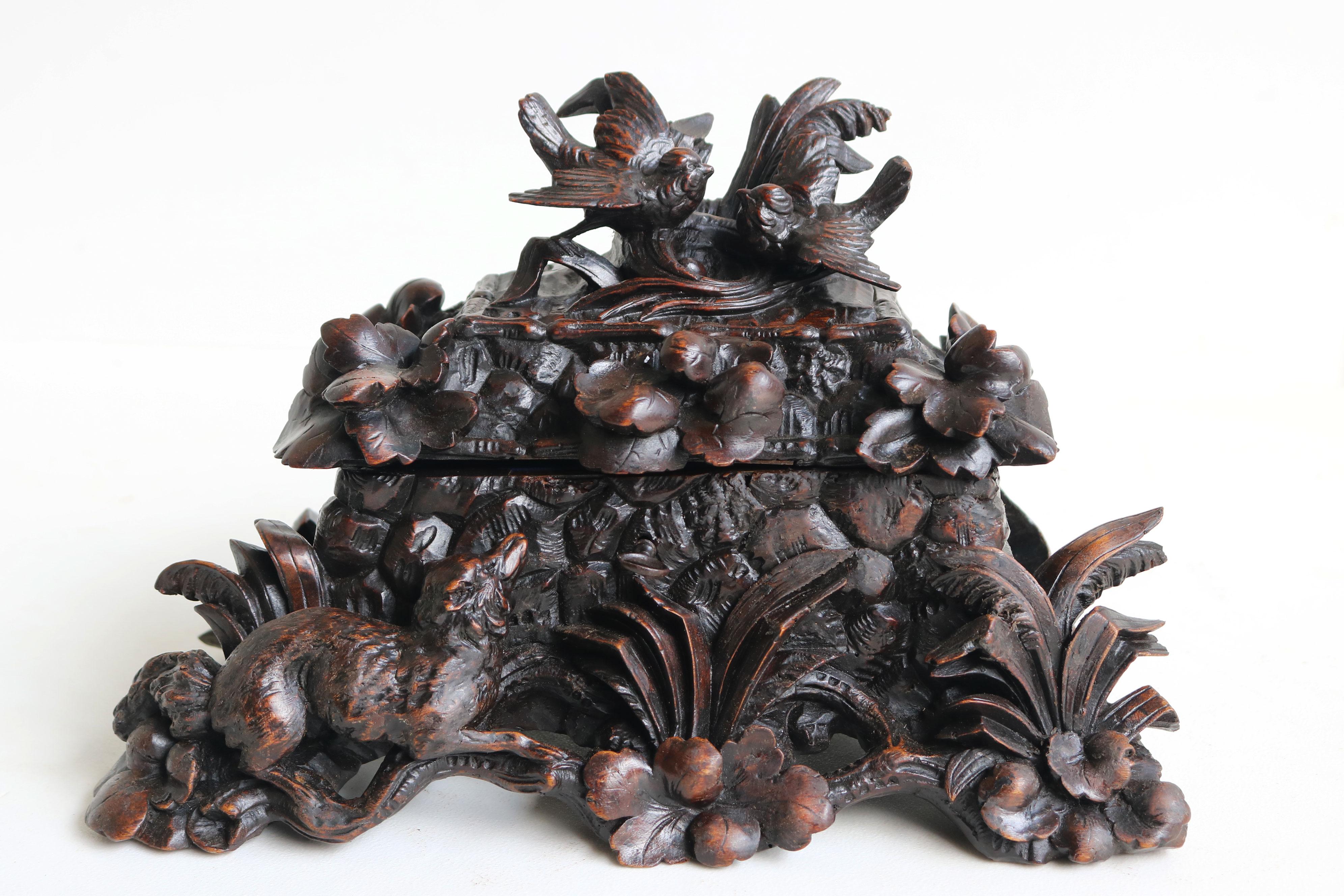 A true masterpiece, this fully hand-carved 19th-century Black Forest jewelry box from Switzerland is a remarkable work of art. Nearly 150 years old, the wood has developed an extraordinary patina, enhancing the beauty of this exquisite piece.