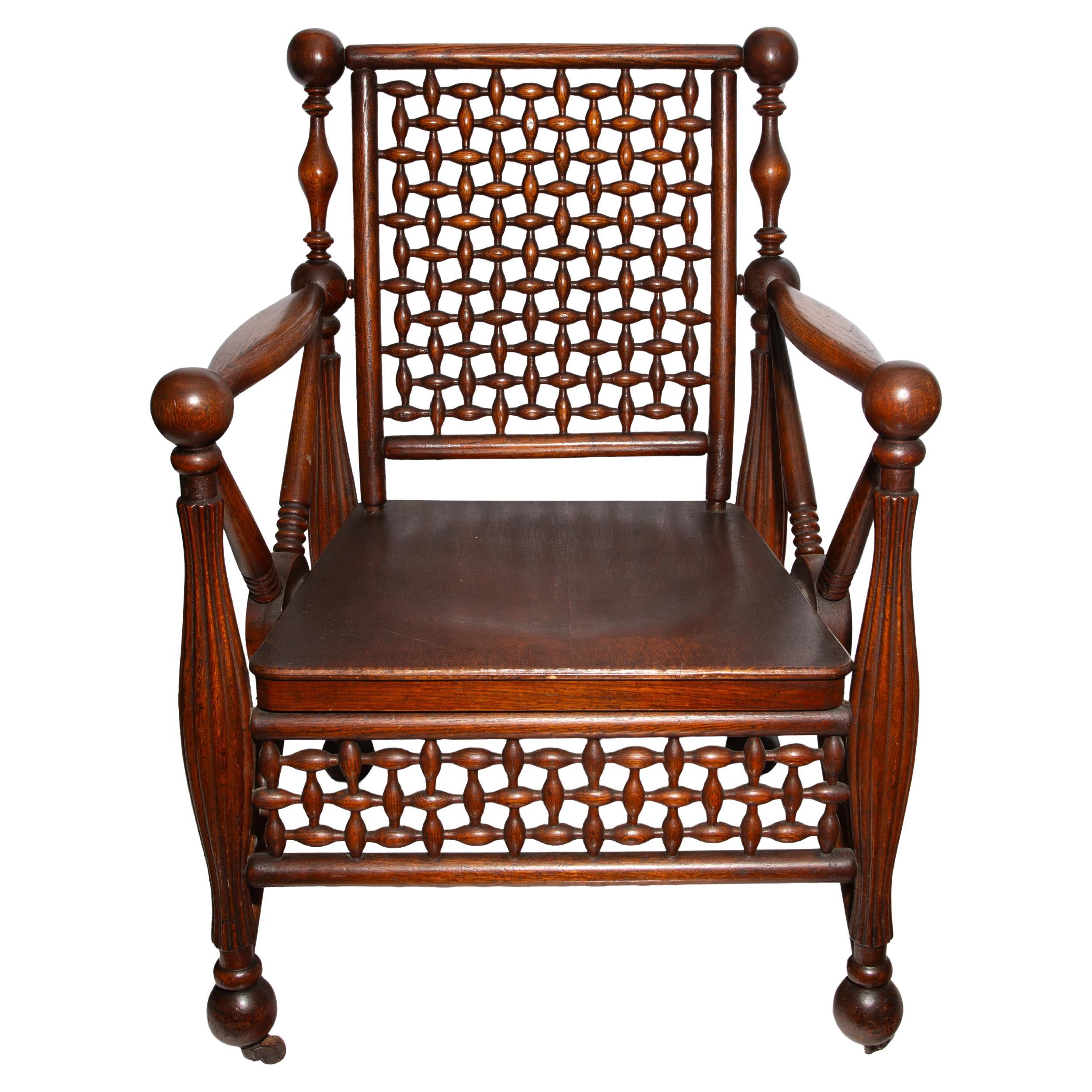 A striking and highly decorative 19th-century aesthetic Movement armchair showcasing exceptional fretwork craftsmanship. Likely attributed to George Hunzinger, a renowned 19th-century American furniture maker celebrated for his innovative designs