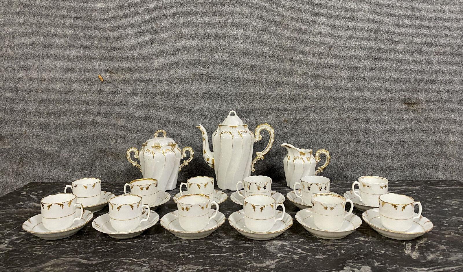 Indulge in the refined elegance of the late 19th century with this exquisite Lyonnaise porcelain coffee service, crafted around 1880. Adorned with delicate golden motifs against a pristine white backdrop, this set exudes timeless charm and