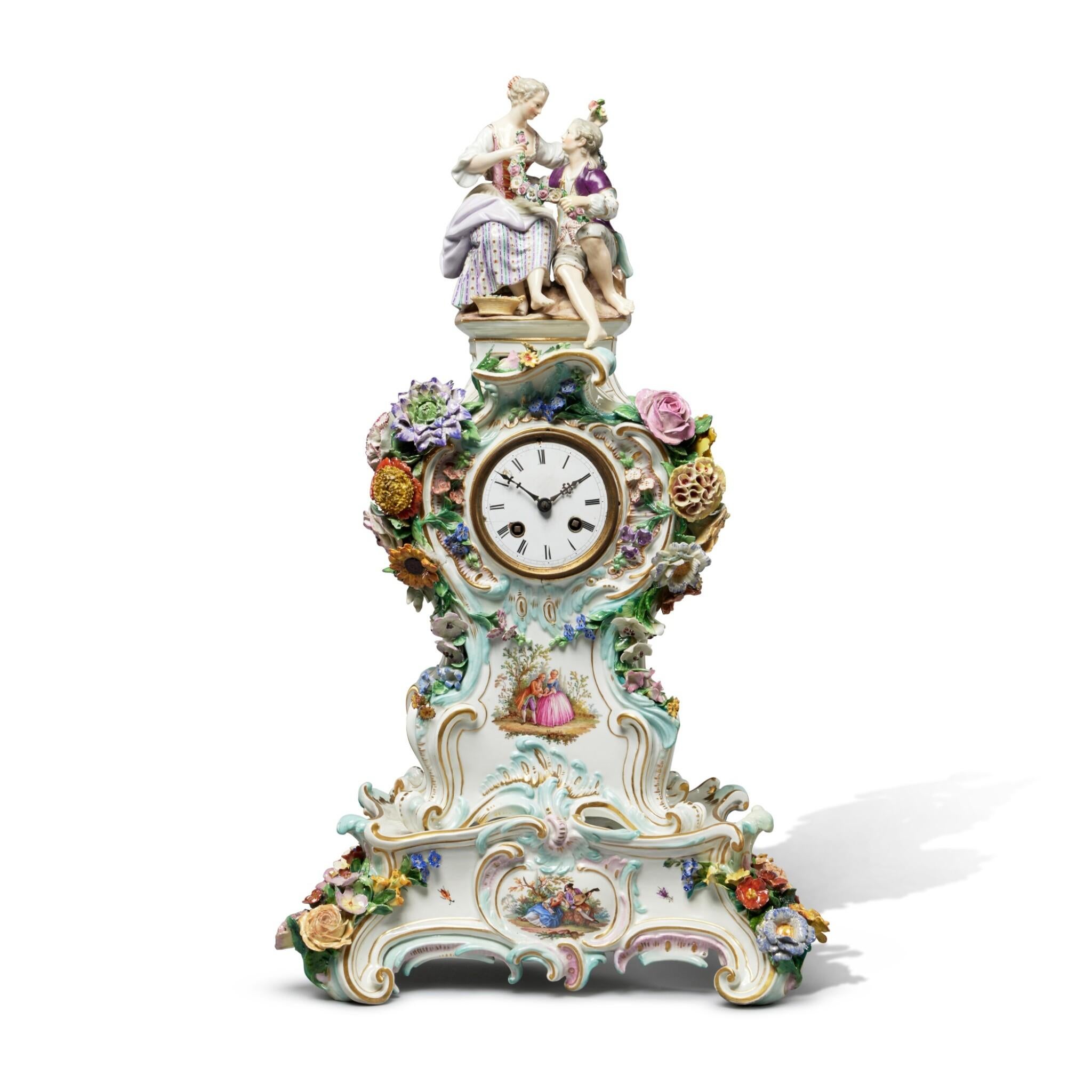 This stunning Meissen porcelain clock case and stand exemplifies the luxurious Rococo style of the 19th century, characterized by its elegant shell and foliate scroll silhouette. The clock is beautifully surmounted by a charming figure group of two