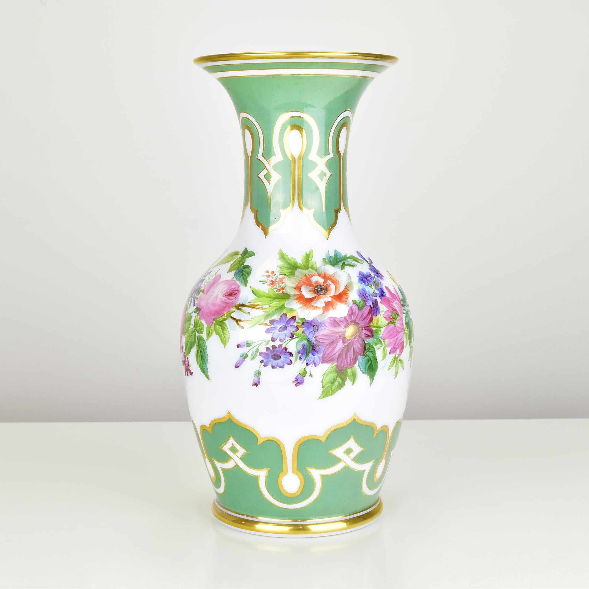 This breathtaking 19th-century opaline glass vase is a masterpiece of fine craftsmanship, likely attributed to renowned French glassmakers Baccarat or Saint-Louis. The piece features an elegant, flared silhouette adorned with intricate hand-painted