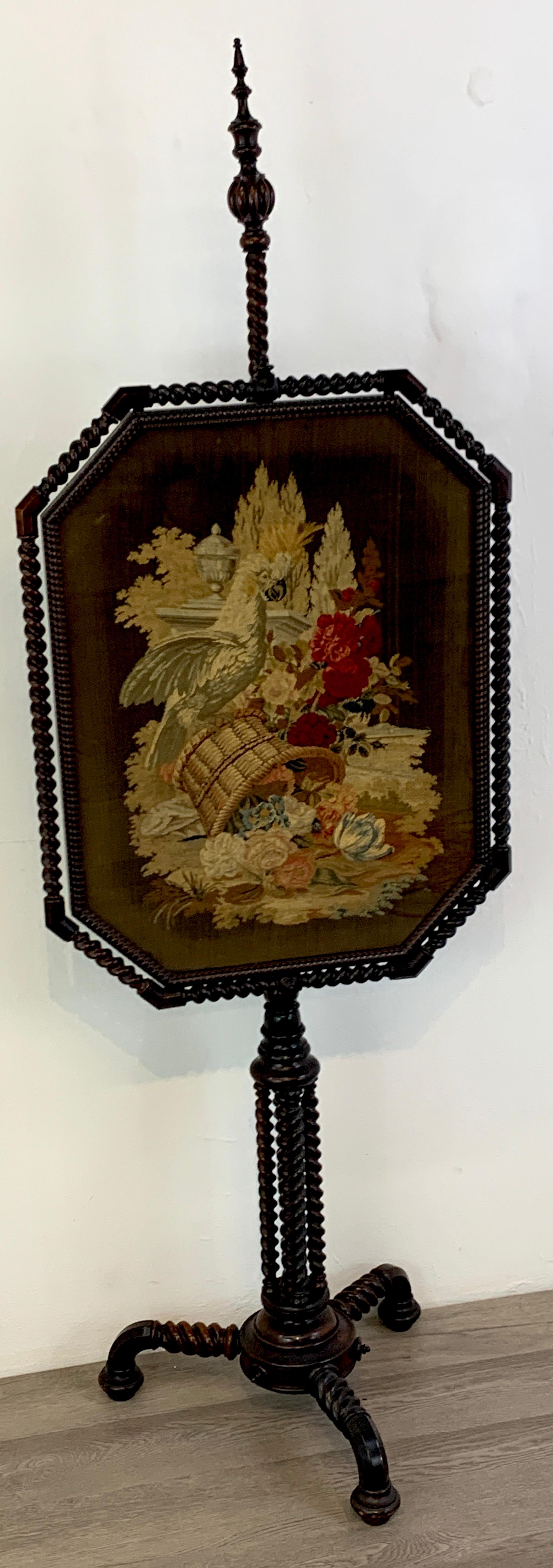 Exquisite 19th century rosewood & needlepoint cockatoo in landscape firescreen, with a nod to Gothic design, this intricately detailed screen is a rare find. With removable carved spiral finial, the moveable framed 30 H x 24