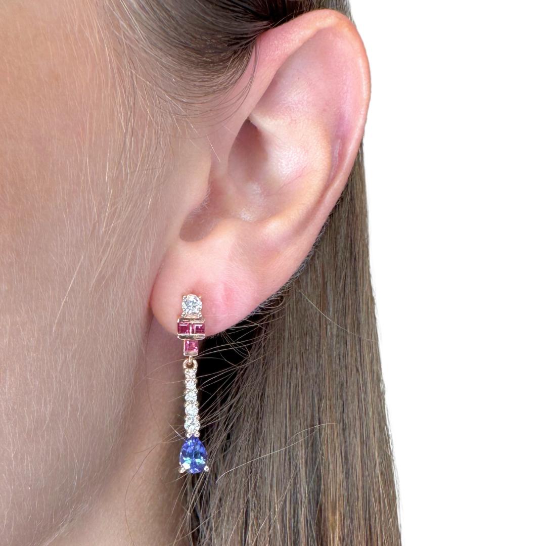 Exquisite 2.11ct Tanzanites, Rubies, and Diamonds Drop Earrings in 18k Rose Gold - IGI Certified

These captivating 18K rose gold drop earrings feature two pear-shaped tanzanites with 1.10ct total in a vivid violetish-blue hue, prized for their