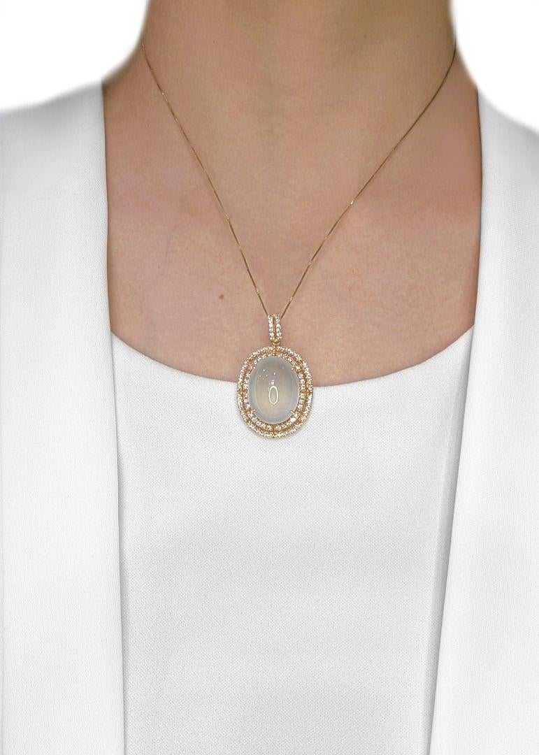 A masterpiece of elegance and prestige, this Ice Jade pendant is meticulously crafted in 18K yellow gold, featuring a stunning 30ct natural Fei Cui (Jadeite Jade, Type A) in an oval cabochon cut, exuding a serene and luminous presence. Accentuating