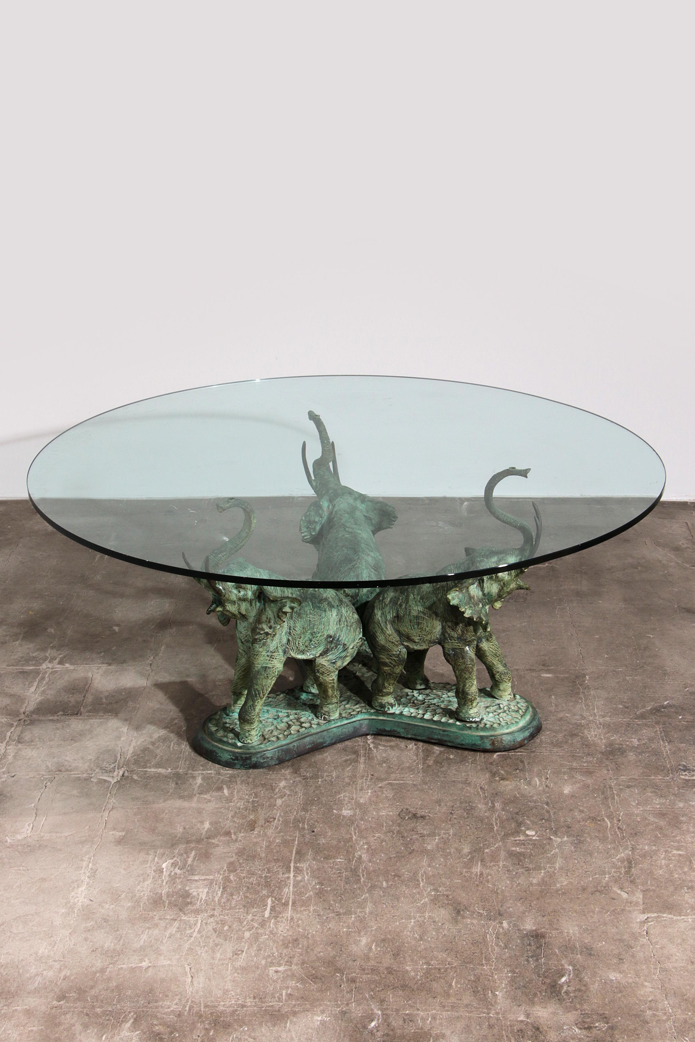 

Discover a piece of history with this exquisite 70s Bronze Elephant Table, a truly unique and heavy masterpiece. Crafted from solid bronze, the intricate elephant sculptures weigh over 50 kg, offering a robust and enduring presence. This table is