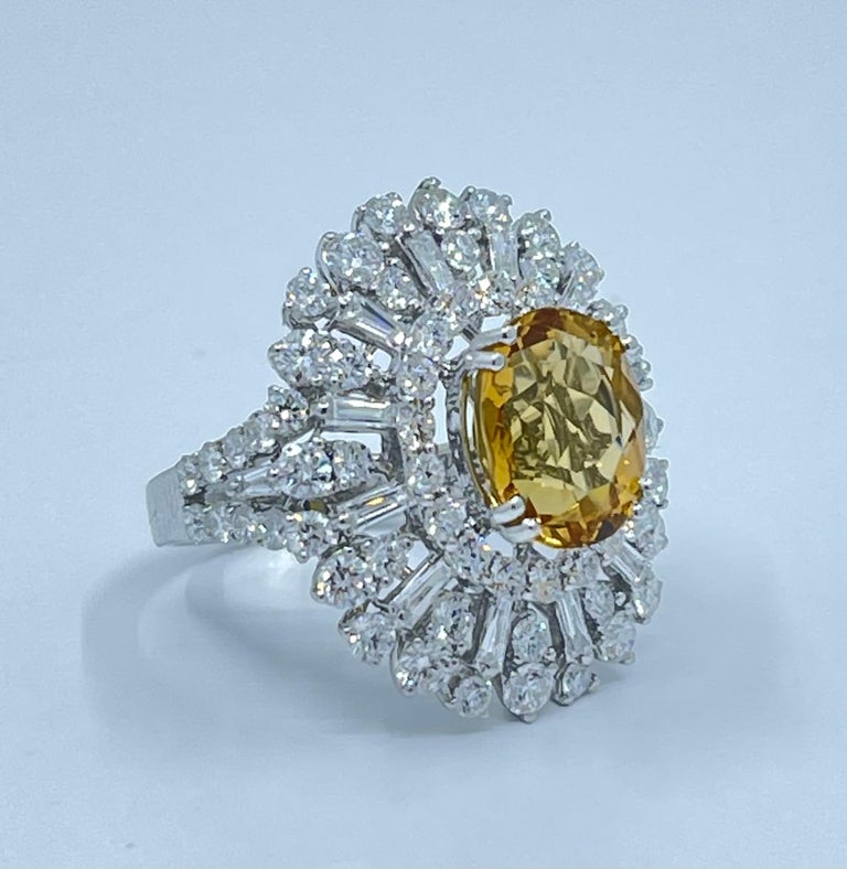 Exquisite estate approximately 9.18 carat total weight natural precious golden yellow beryl aka heliodor and diamond cocktail ring is set in 18 karat white gold.  The golden yellow center stone is surrounded by a halo of the most sparkling round