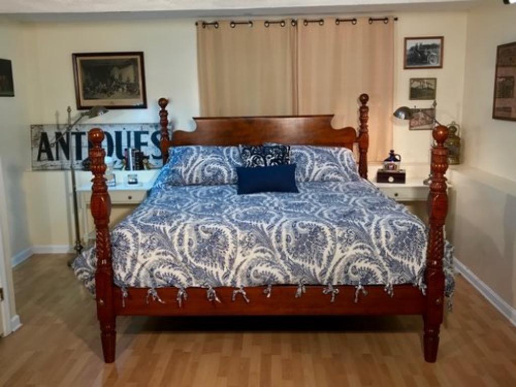 Exquisite acanthus carved cannon ball low post bed in tiger maple circa 1820 Refitted to a Standard King with a bend back, bird's-eye maple paneled headboard. Provenance: Connecticut. 

All beds come with bolts, bolt covers and a bed wrench. All