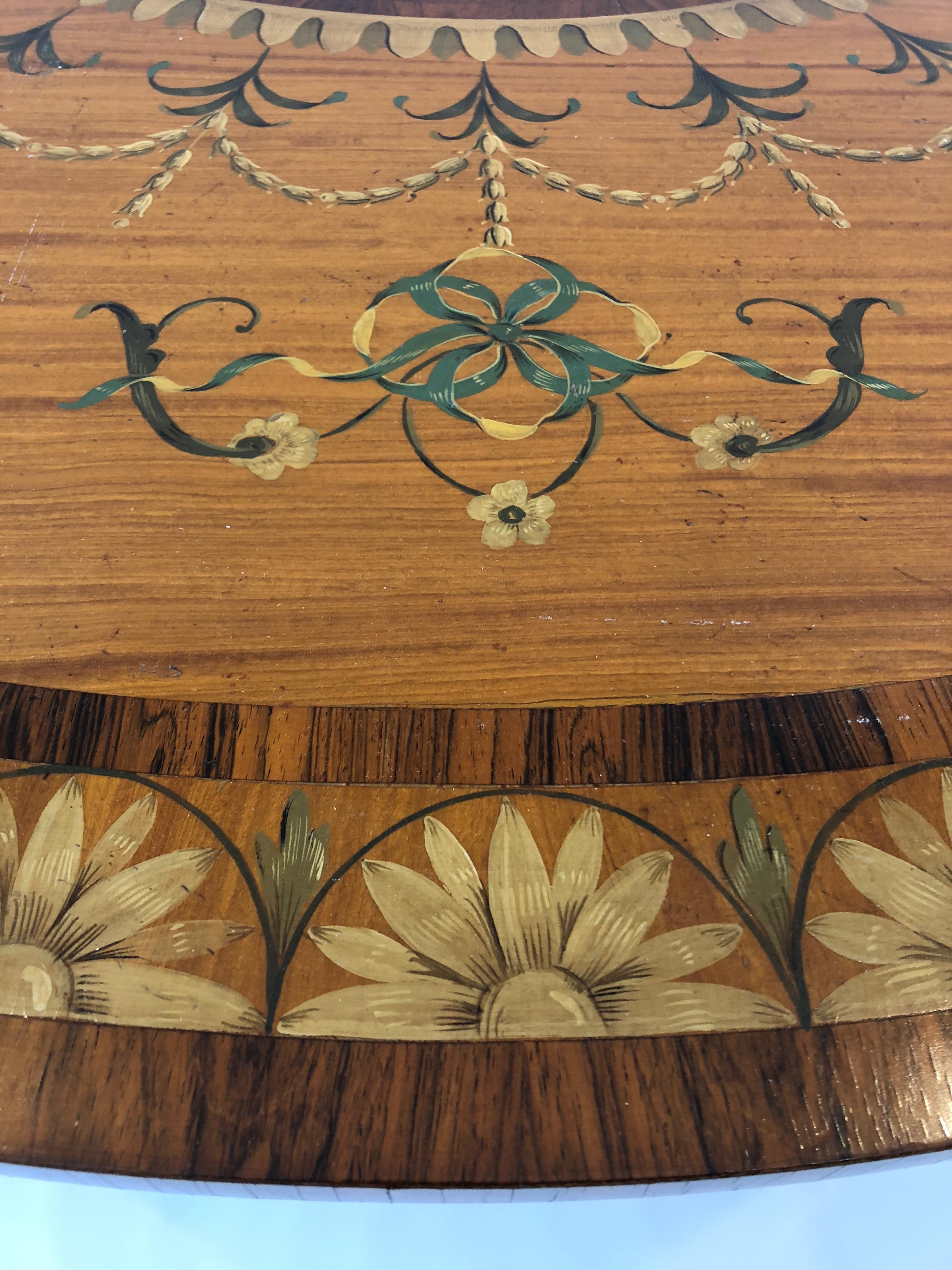 Sublime satinwood demilune console table having meticulous hand painted decoration and inlay in rosewood and ebony.