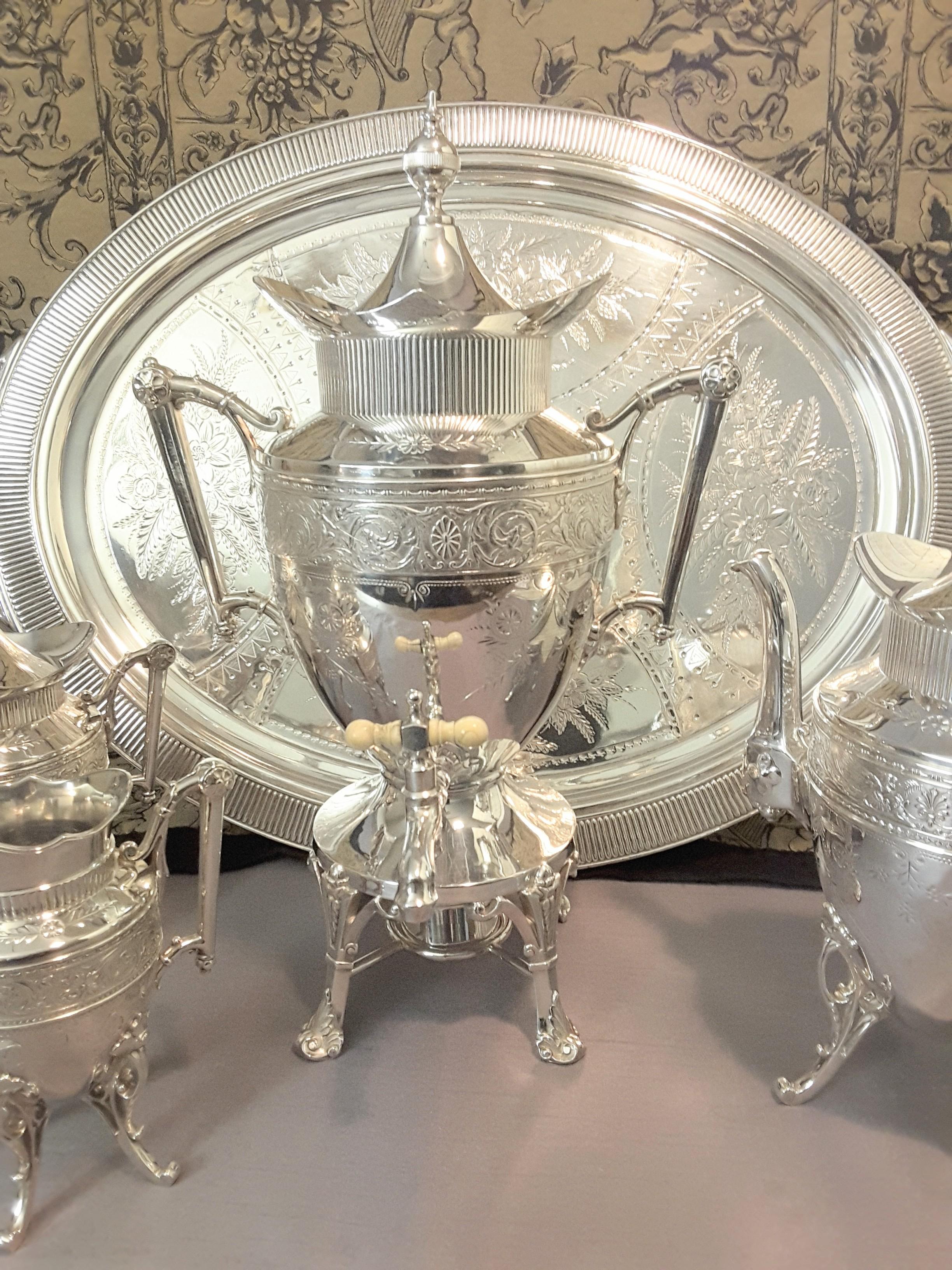 Exquisite Aesthetic Movement Silverplated Tea Service by Simpson, Hall & Miller Co. circa 1870-1890, large scale set consisting of a hot water kettle on stand with under burner, tea pot, covered sugar and creamer with a very large tray measuring 31