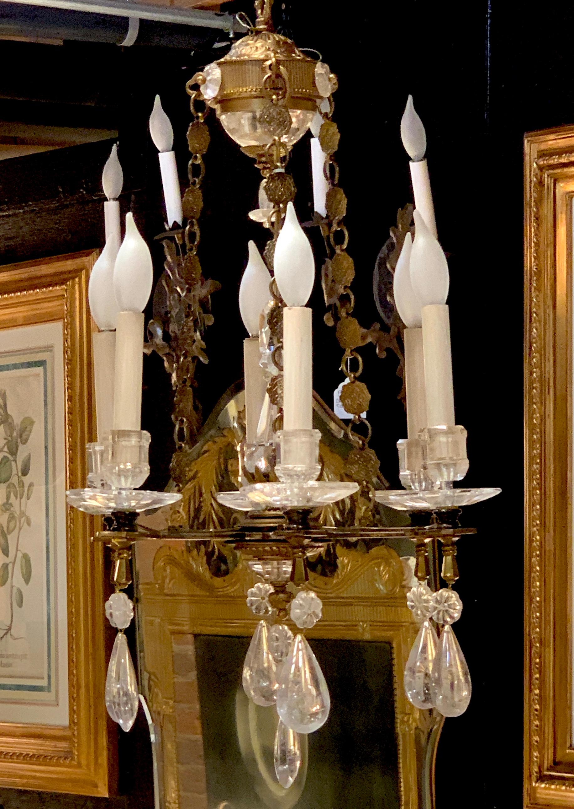 Exquisite all rock crystal and gilt bronze six-light boudoir chandelier, of diminutive and yet having a substantial presence this six light all carved rock crystal including the candlecups and bobeches, and the center spheres. This chandelier