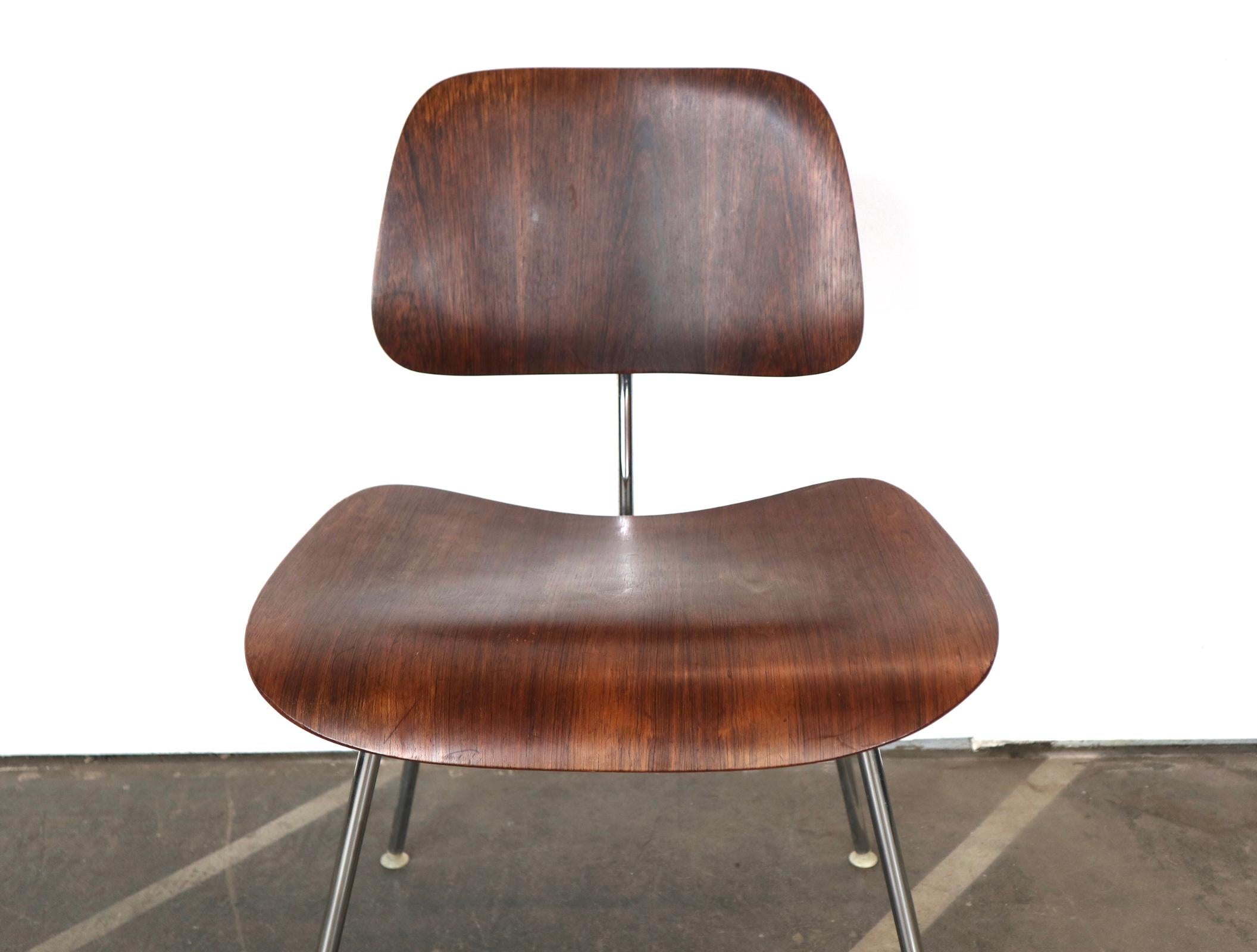 These don’t turn up very often. A rare rosewood DCM chair designed by Charles and Ray Eames for Herman Miller. Rosewood was not a standard finish and was only available by custom special order. The chrome frame and wooden panels are in good vintage