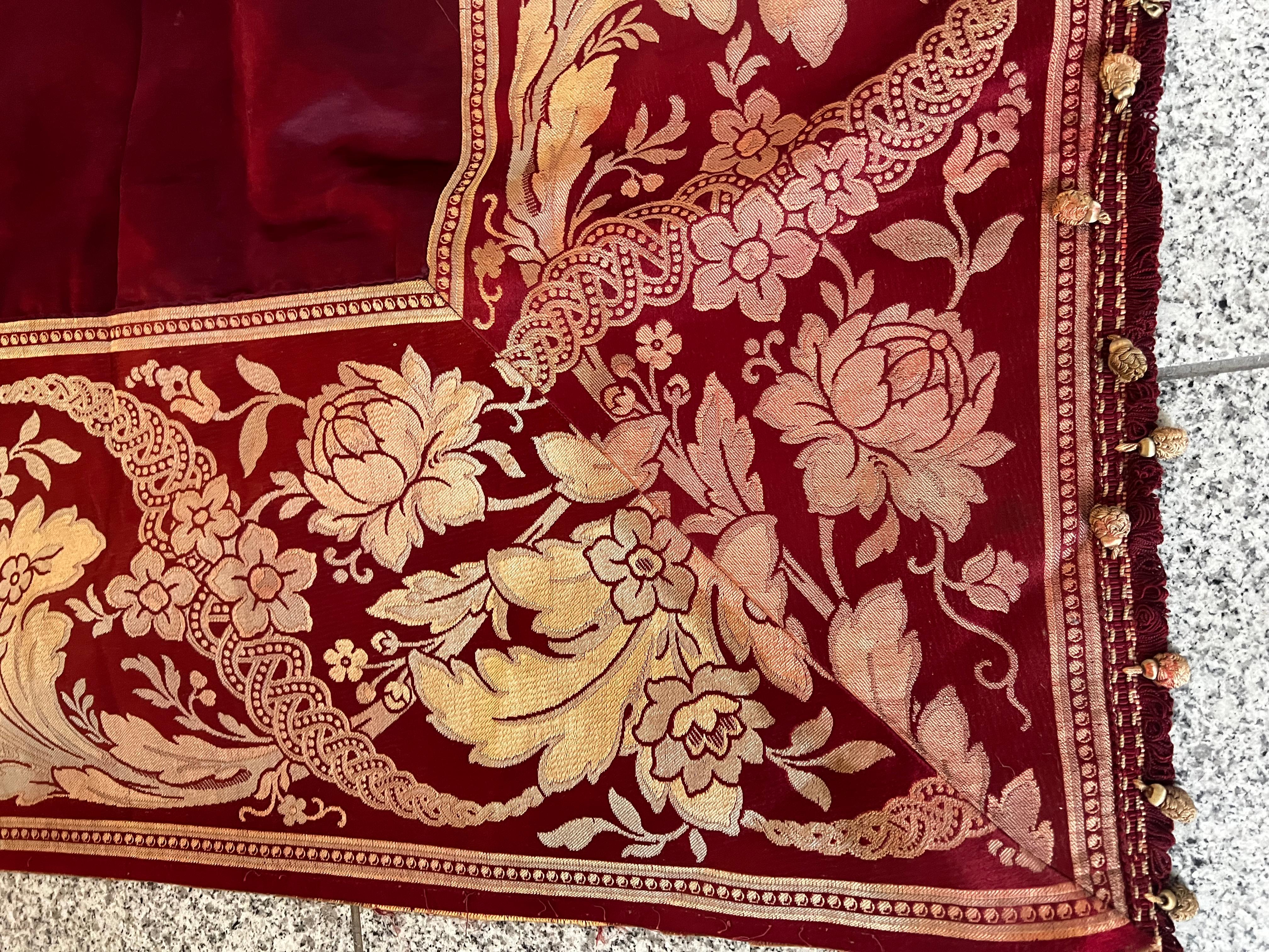 This is an absolutely exquisite, fine and rare 100% silk Venetian material/ fabric. It has a deep red wine very attractive and luxurious general main color, each border has a floral ornamentation and top and bottom has a little tiny tassels which