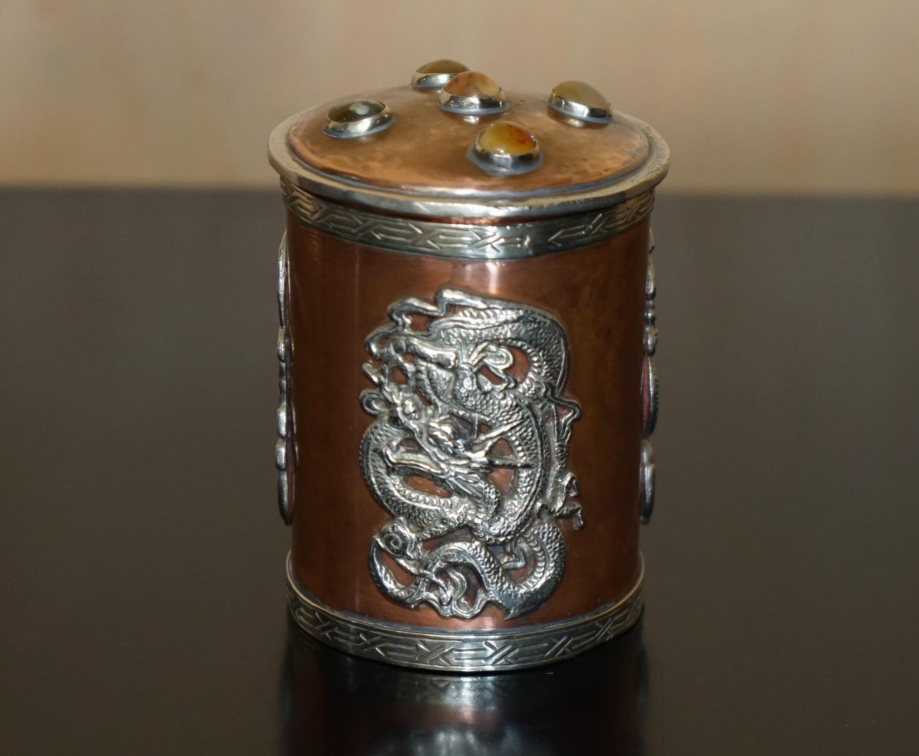 Royal House Antiques

Royal House Antiques is delighted to offer for sale this absolutely exquisite Meiji Dynasty Copper pot with Silver dragons and Cabochons to the top

A very good looking well made and decorative pot, the dragons polish as