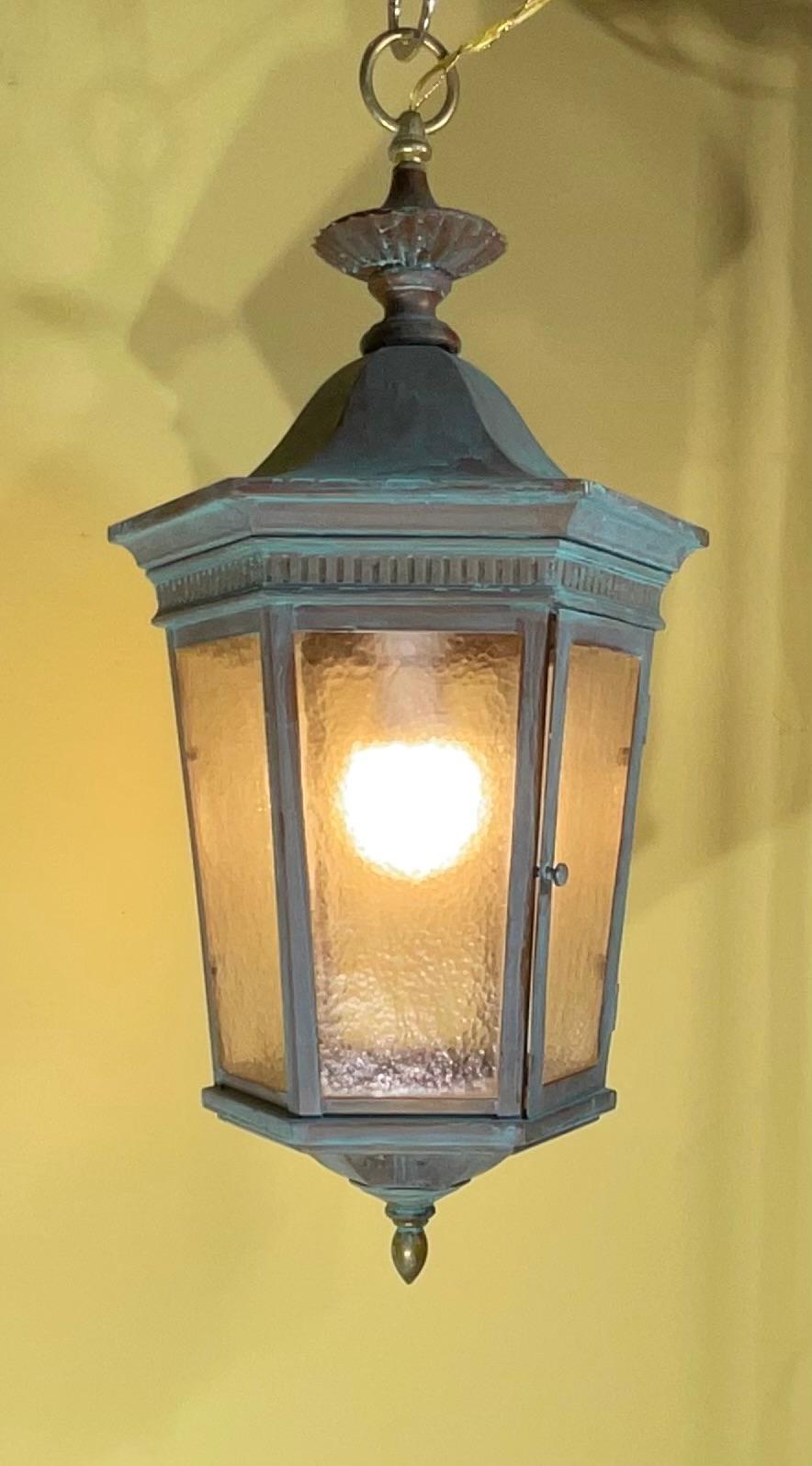 

Bring a touch of timeless elegance and warm, inviting light to your home with this truly remarkable antique copper hanging lantern. This isn't just a light fixture; it's a piece of history, meticulously transformed into a functional and stunning