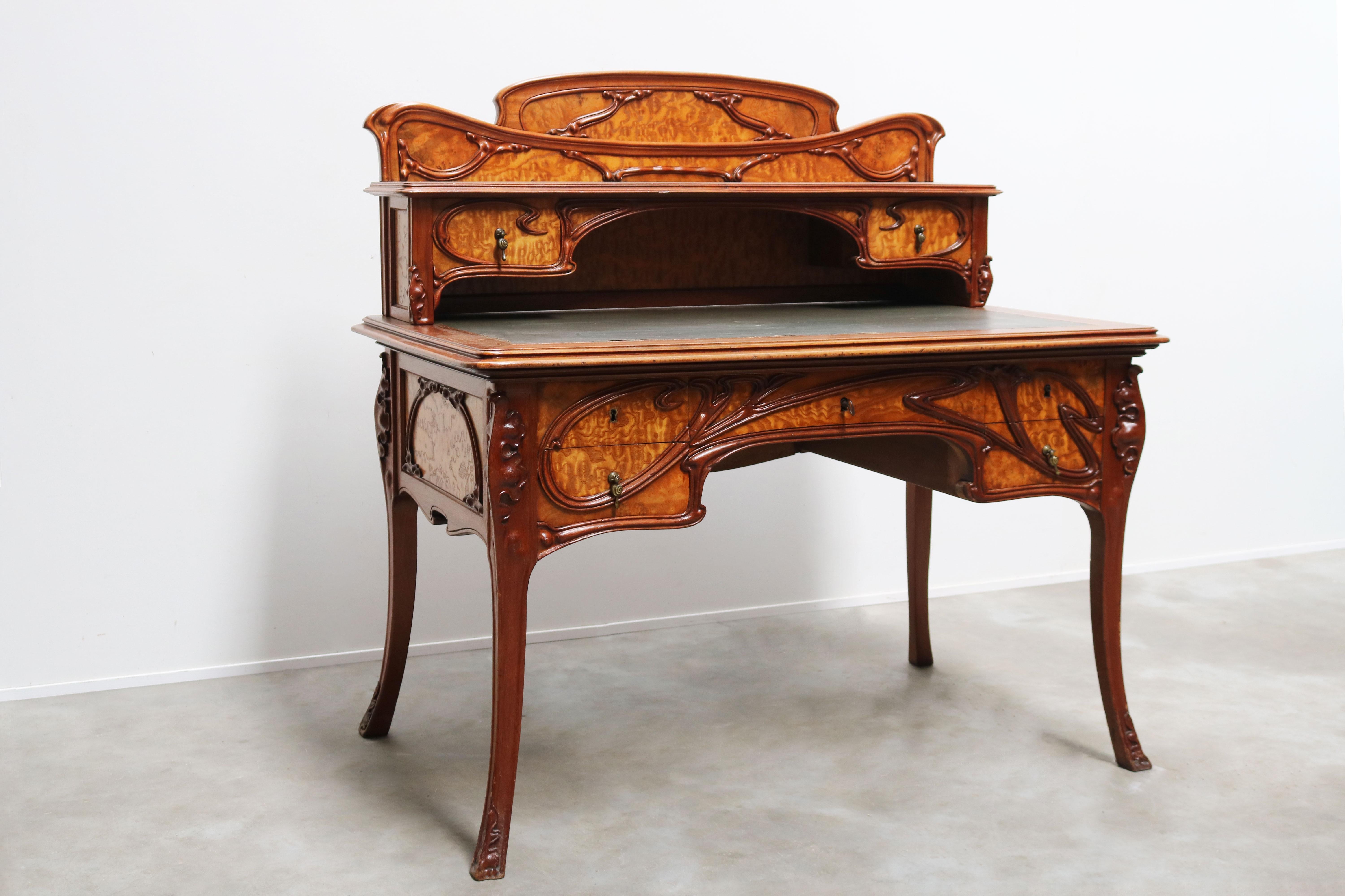 Simply exquisite antique French writing desk in the Art Nouveau design style made in 1895. 
A marvelous combination between Walnut & Japanese ash wood. The typical organic lines & floral decoration fitting for the art nouveau movement. One very