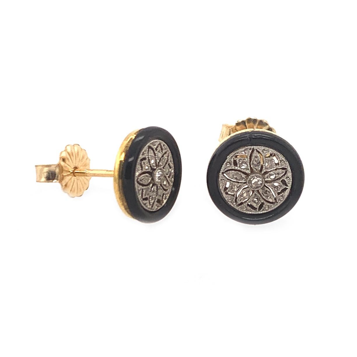 Shimmering stud earrings:  onyx frame around an intricate openwork floret design diamond center.  The diamonds are  all original and are set in platinum.  Milgrain detailing.  14K mellow yellow gold backings and posts. Petite size, measuring 0.37