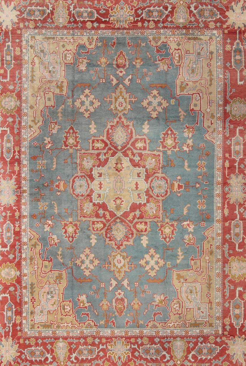 Hand-Knotted  Antique Turkish Oushak Rug On A Blue Background and Orange-Red Color Border For Sale