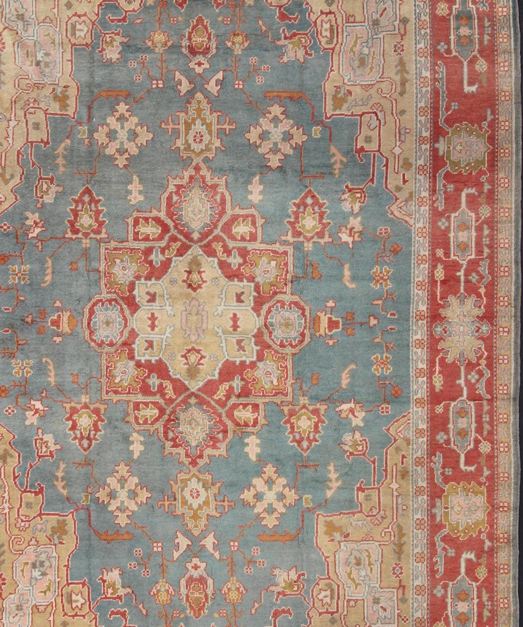  Antique Turkish Oushak Rug On A Blue Background and Orange-Red Color Border In Good Condition For Sale In Atlanta, GA