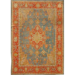 Exquisite Antique Oushak rug in Blue Background and Orange color Border