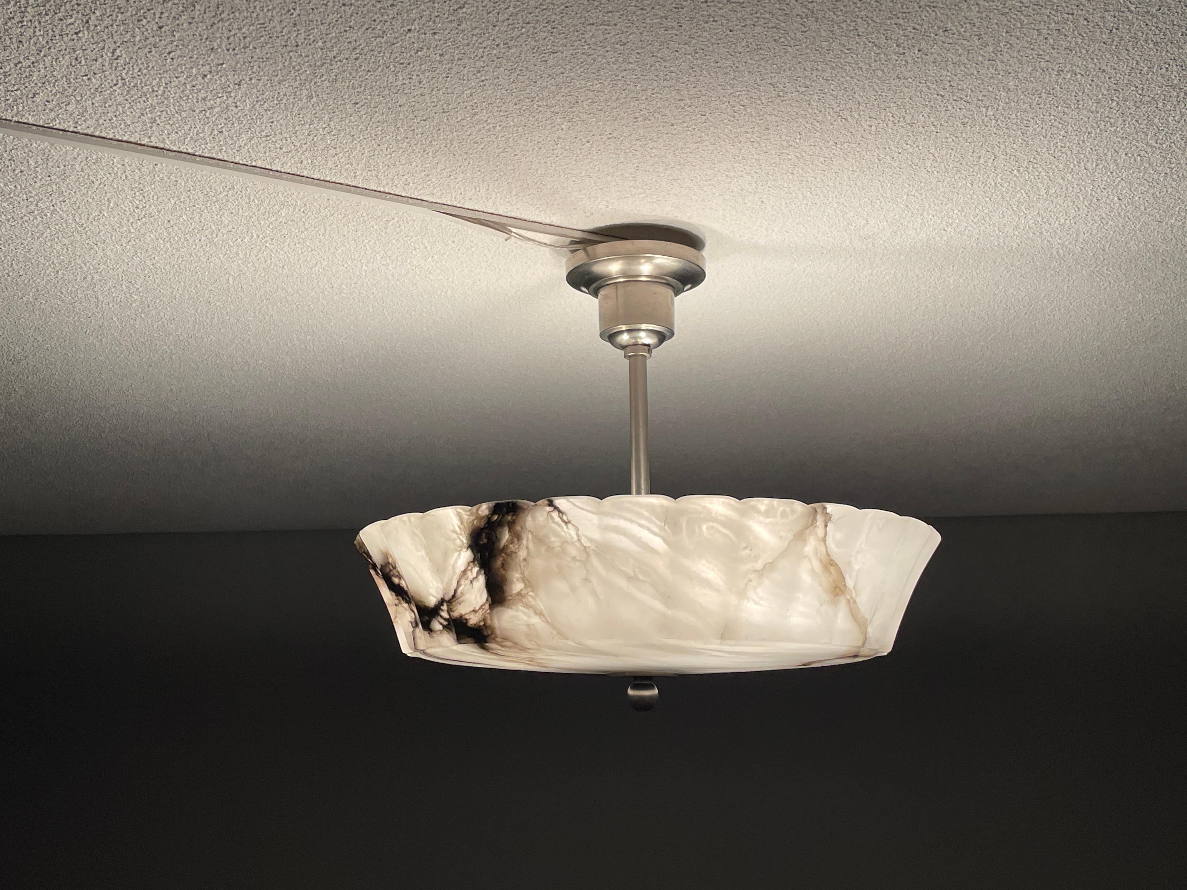Rare and majestic, three light alabaster flush mount from the heydays of the Art Deco era.

This rare and good size Art Deco flush mount comes with a stunning design and a superbly polished alabaster shade. This almost flat at the bottom alabaster