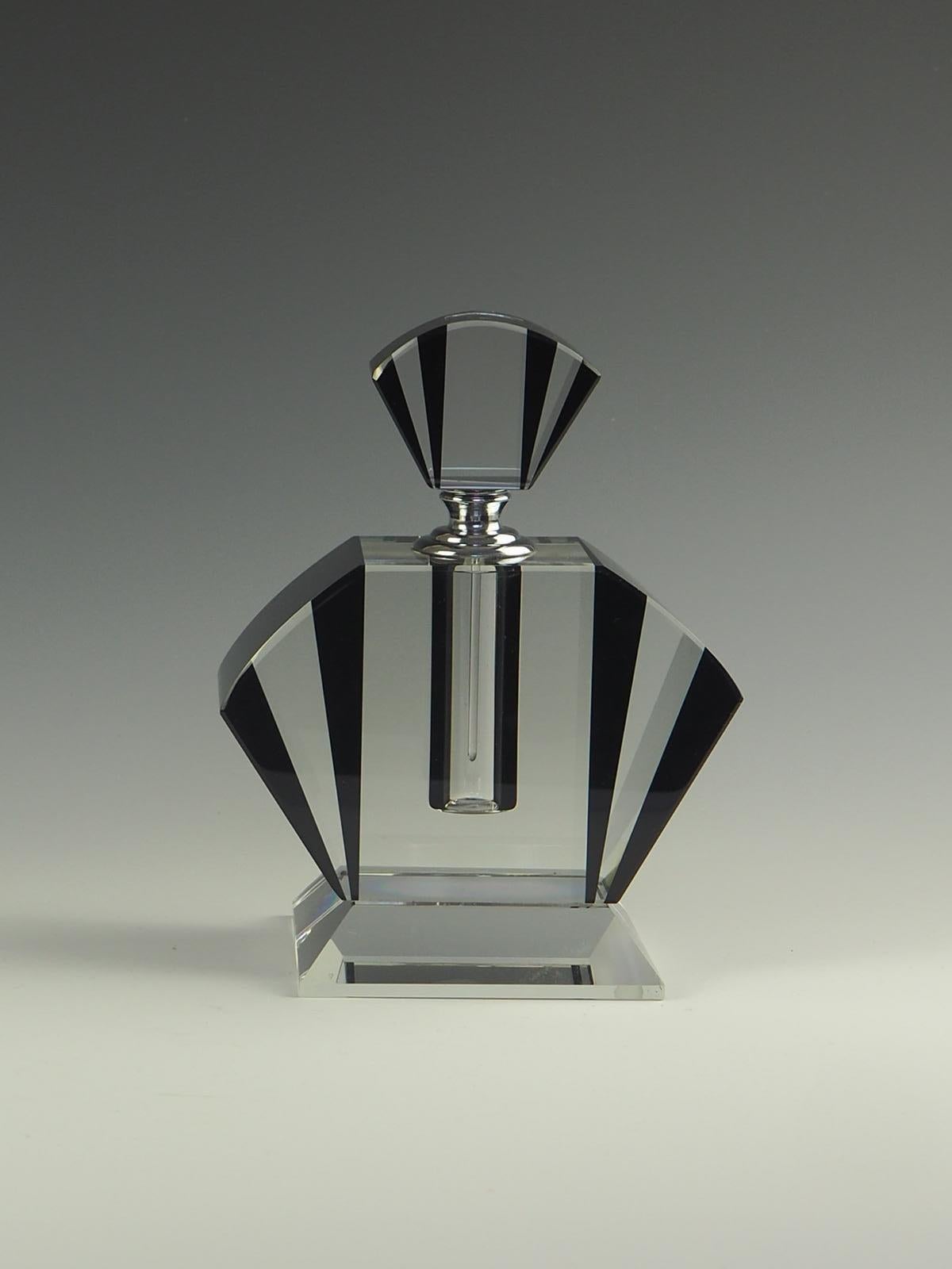 Exquisite, classic Art Deco perfume bottle.

Classic crystal perfume bottle in true Art Deco style.

Geometric fan shaped clear crystal and black opaque glass, silver colored collar.

The glass pipet scent rod is in perfect condition.