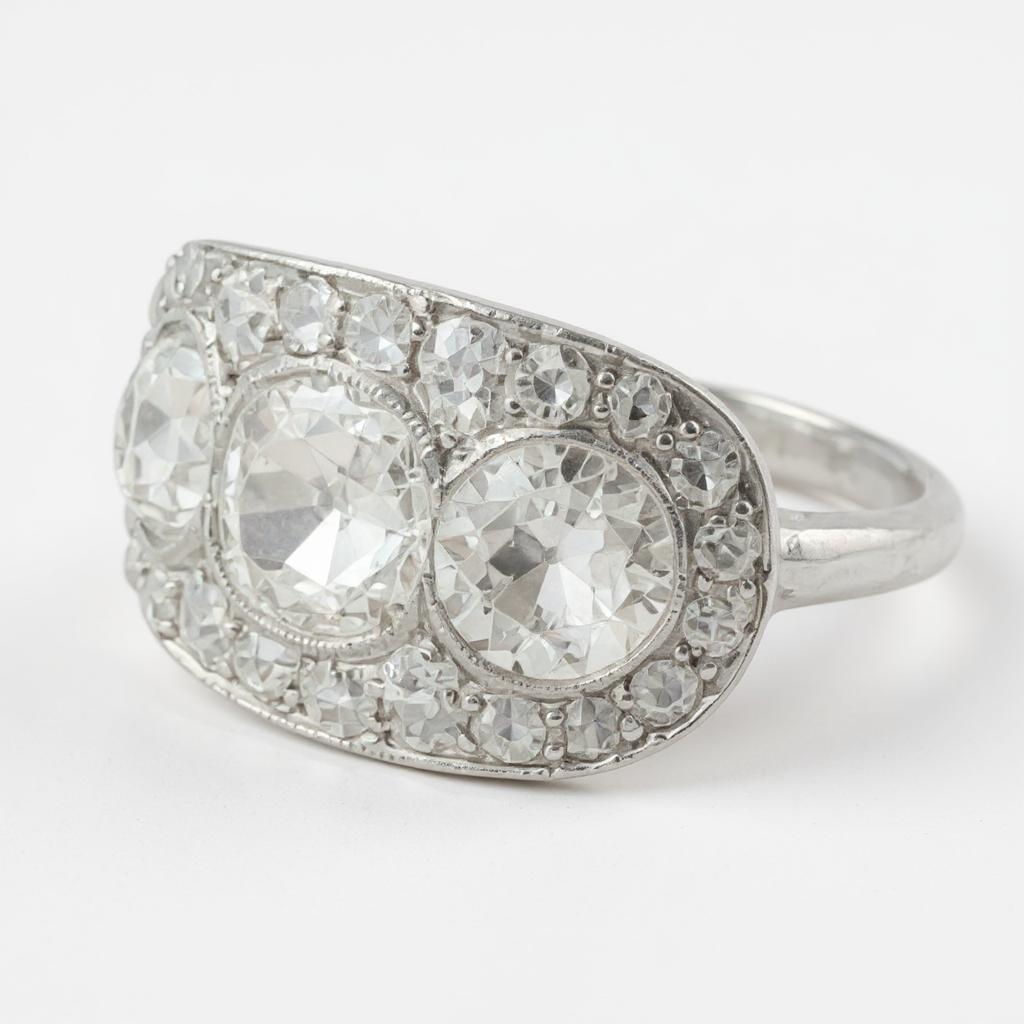This stunning Art Deco platinum ring showcases timeless elegance and masterful craftsmanship. At its center, a magnificent European cut diamond weighing approximately +- 1 to 1.15 ct  carat commands attention, flanked on each side by two European