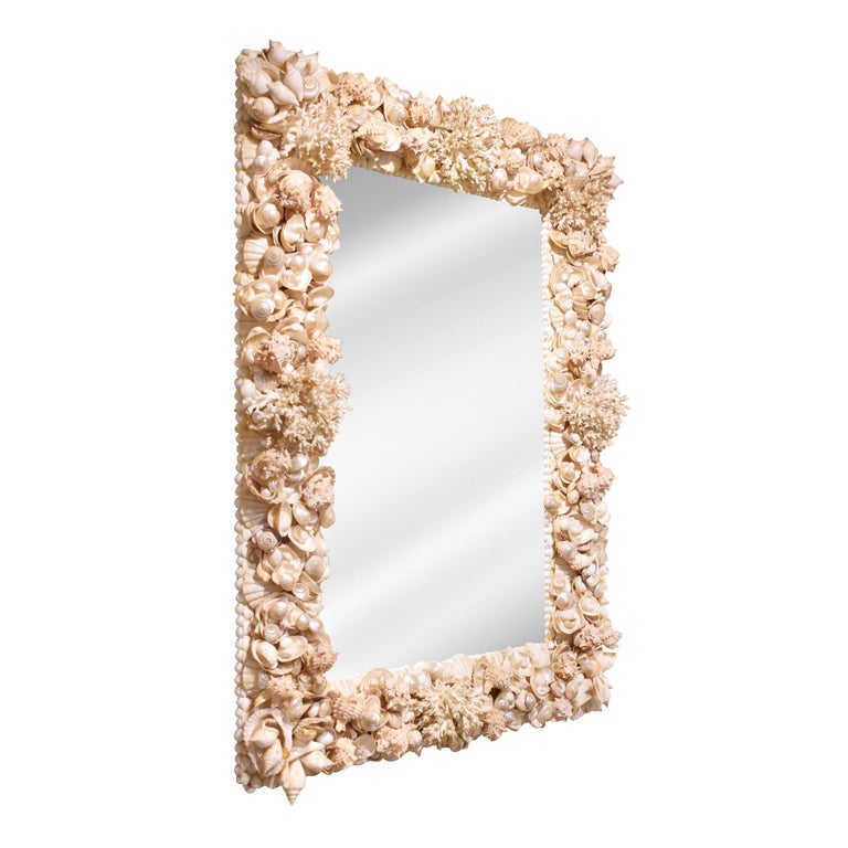 Elaborate and finely crafted artisan mirror of sea shells and coral, custom design, American 1970's. This mirror is very luxurious and impressive in person.