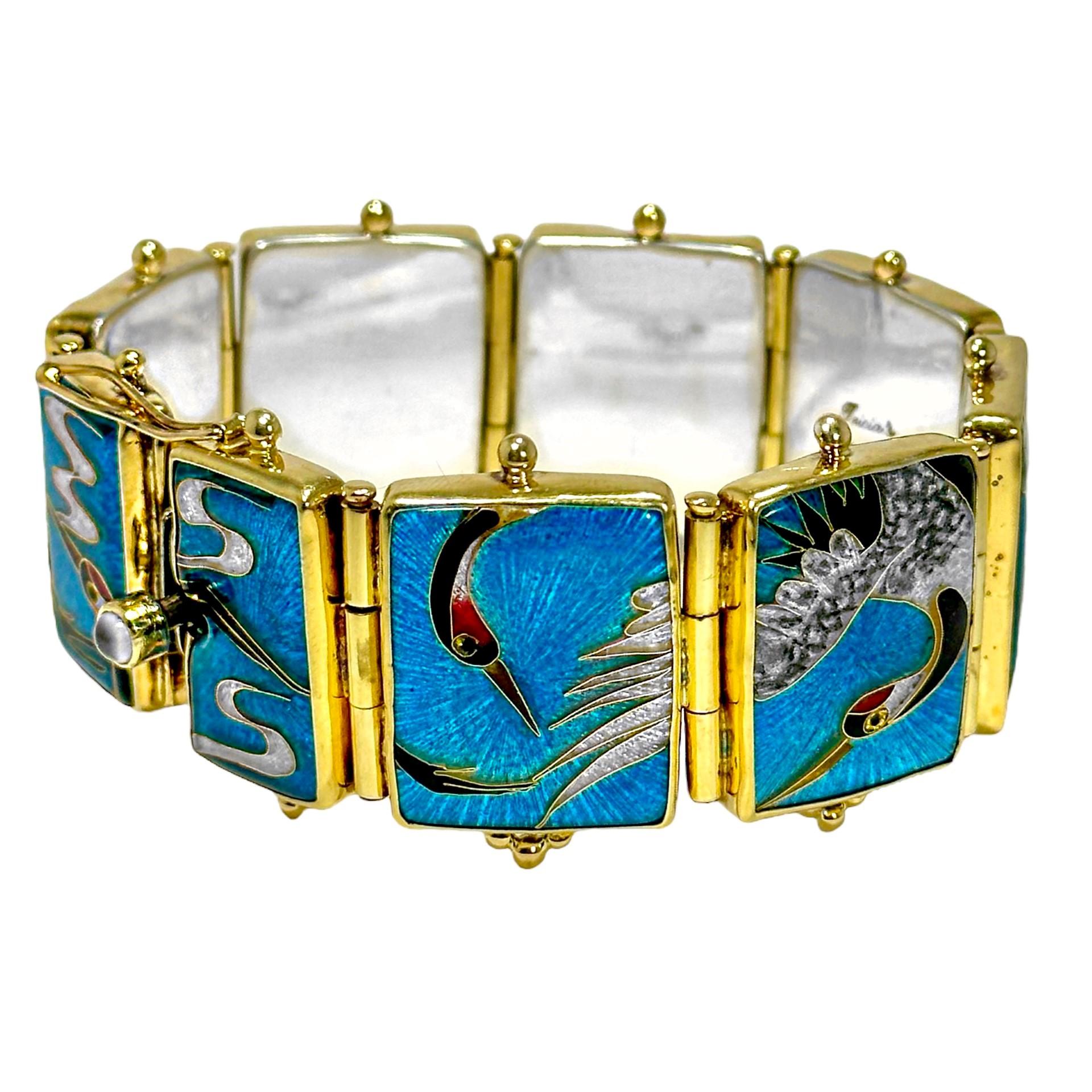 This truly spectacular early 21st-Century designer bracelet is made of 18k, 22k gold, and sterling silver. It is a vibrant, imaginative, and very well executed example of absolutely top level cloisonne enamel artwork. Having nine panels artfully