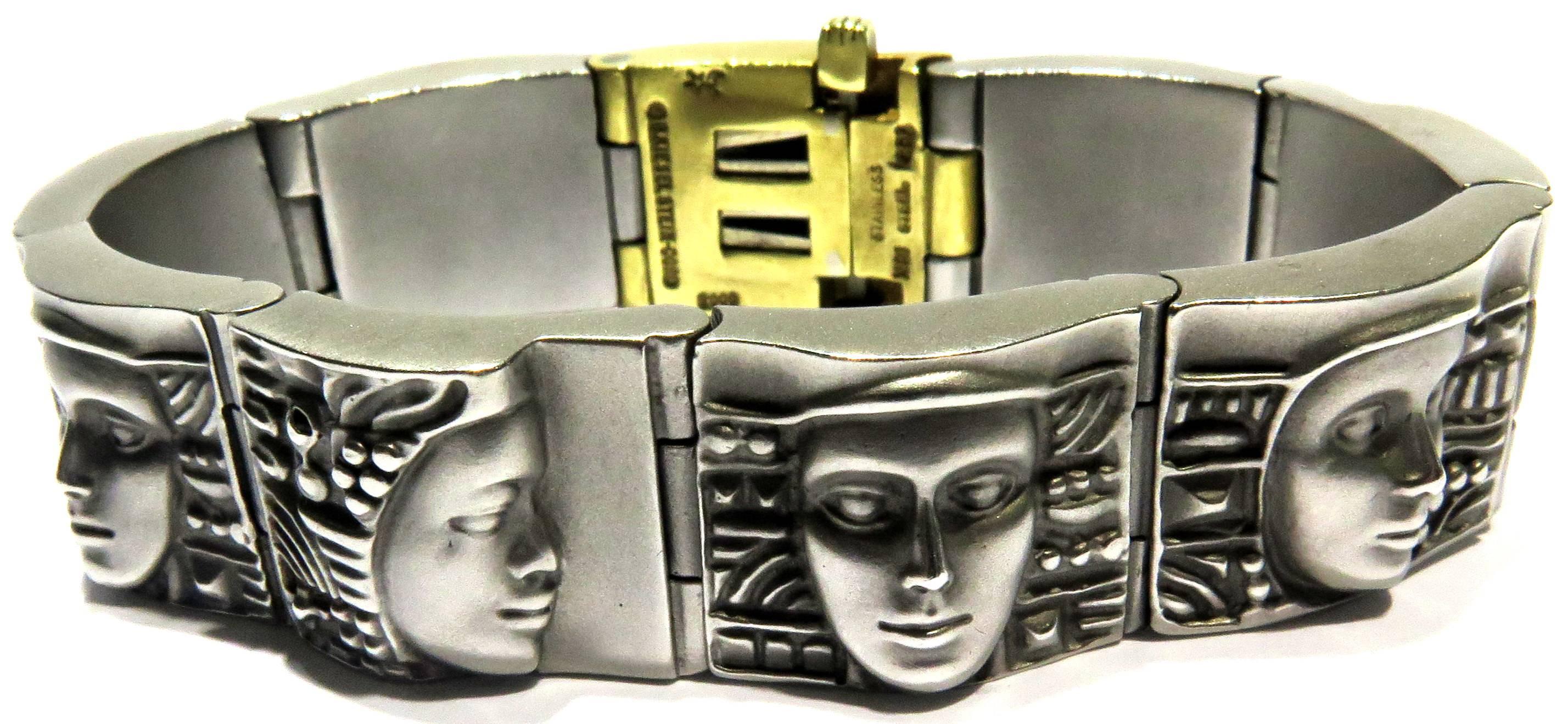 This 18 Karat and Art steel bracelet features a dramatic 9 portrait motif link with matte and textured finish throughout and side lock closure.  This famous Barry Kieselstein-Cord design is part of NYC's Metropolitan Museum Of Art collection.  This