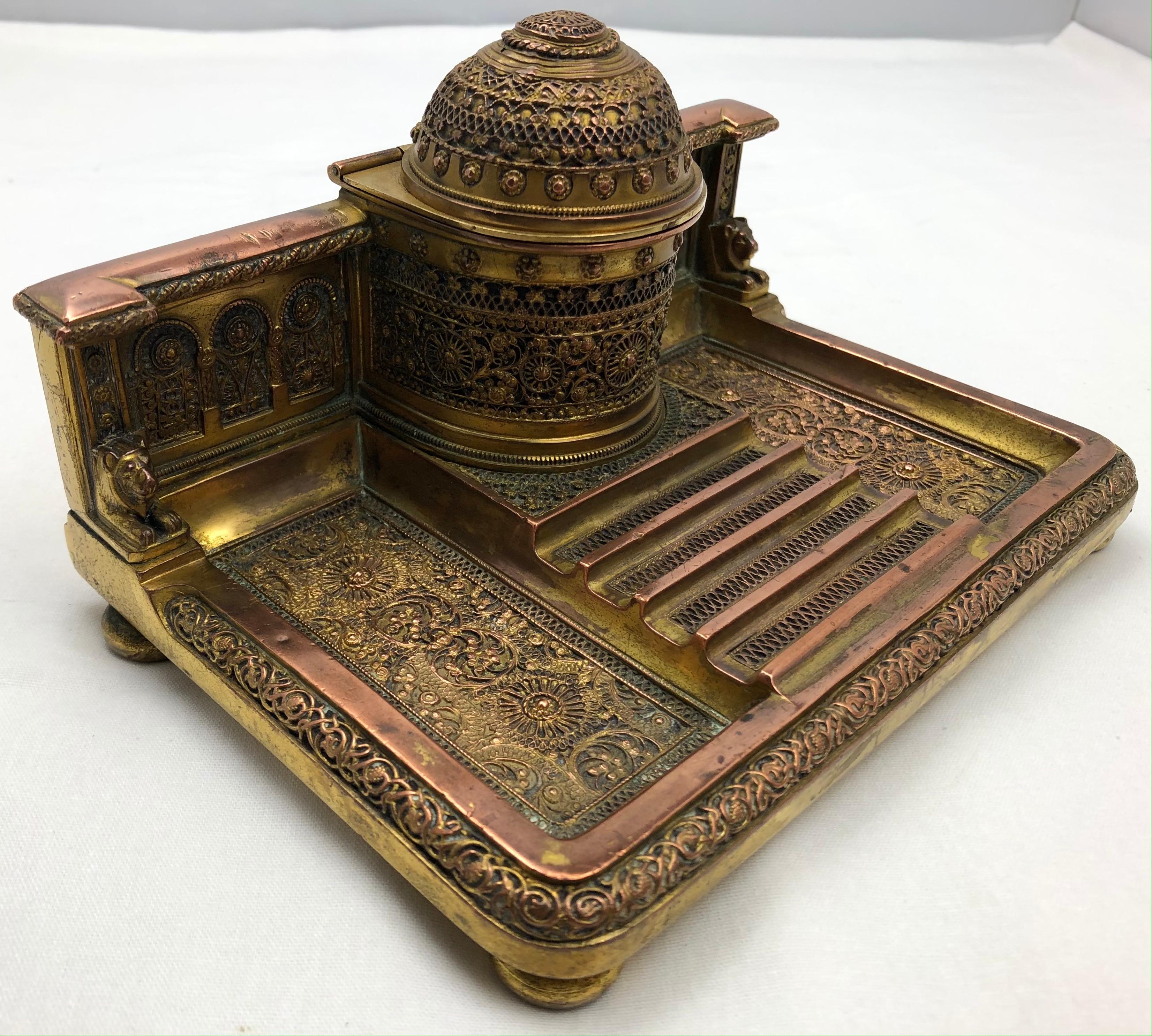 Exquisite Bizantine French 19th century Empire Napoleon III gilded bronze inkwell.
This handcrafted antique desk accessory bears the makers mark on the bottom is of exceptional quality. The details are stunning, features a crown finial top, classic