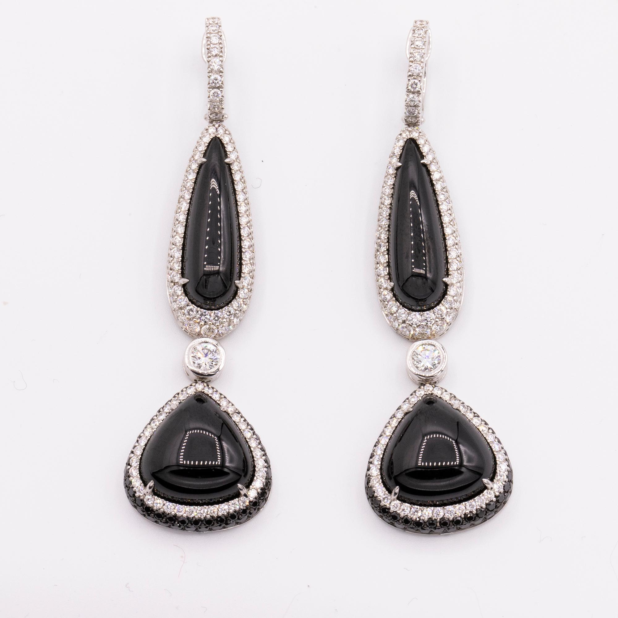 From Hamilton's Lisette Collection, handmade drop earrings with cabochon black spinels framed with white and black diamonds and set in 18k white gold.

black spinel = 52.07 carat total weight
2 larger diamonds, =.50 carat total weight
framed by